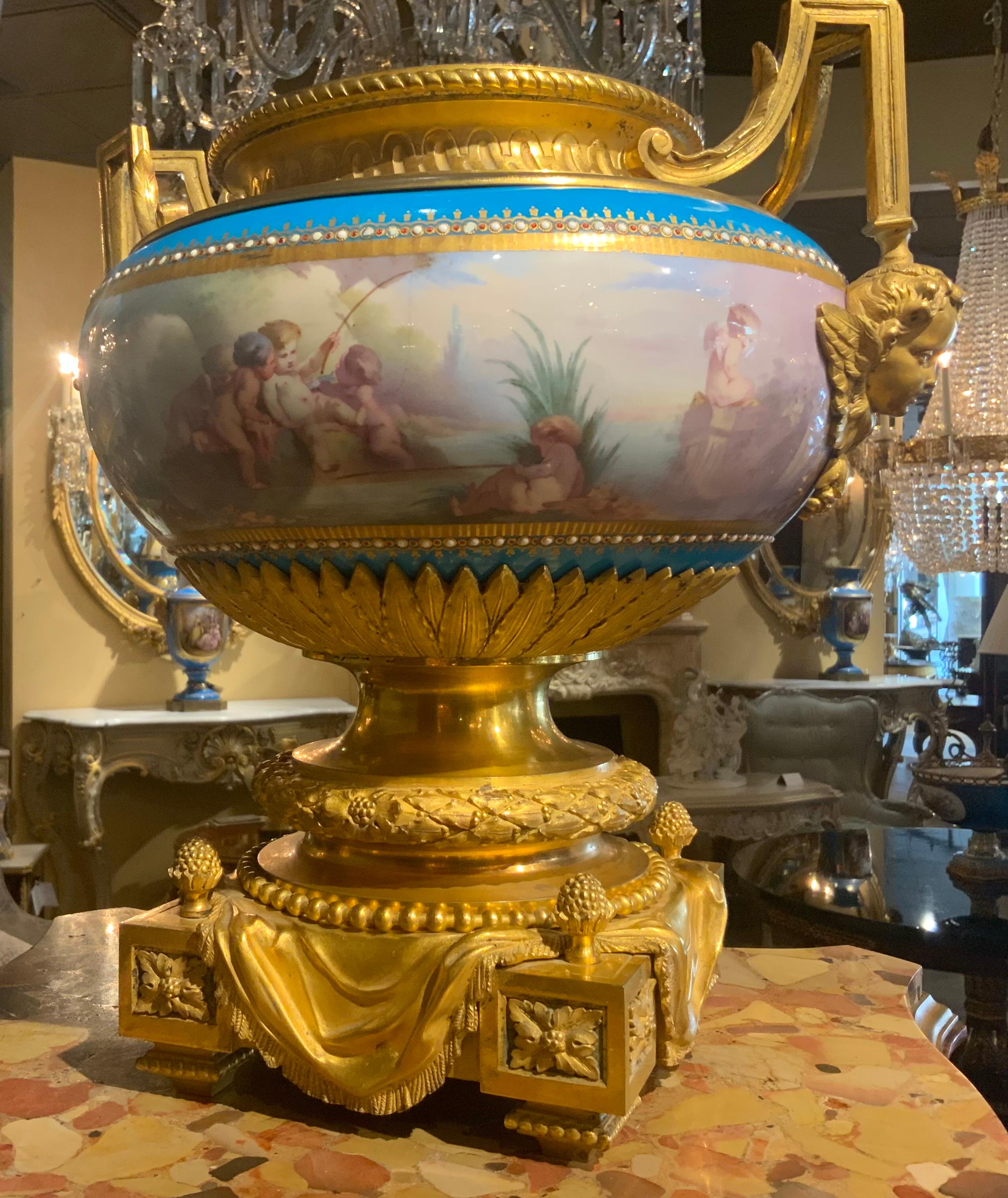 Incredible quality and artistic ability is inherently 
Visible in this pair of jardineres. The casting and
Gilding of the bronze is of special workmanship.
The porcelain is artistically painted depicting 
Playful putti. The porcelain is in