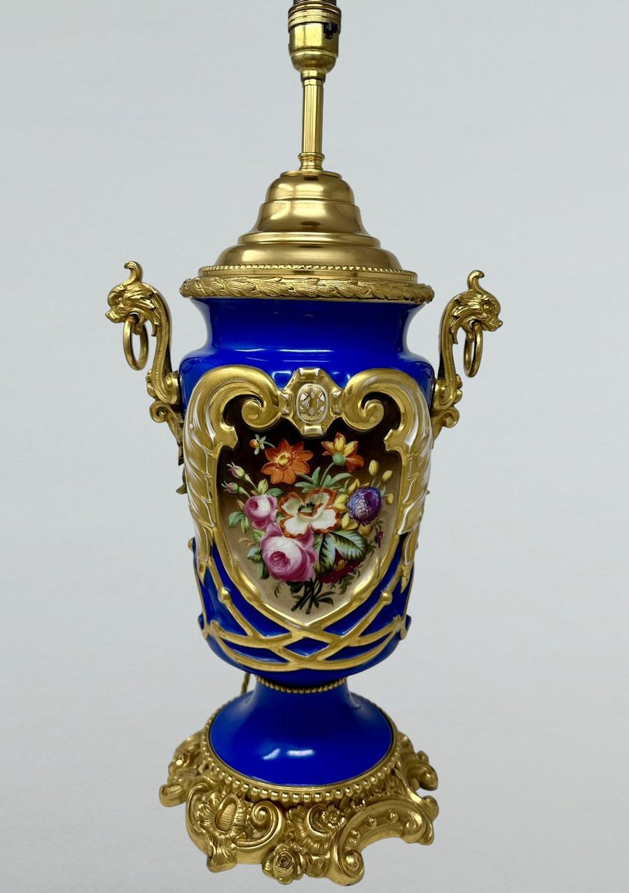 Stunning French Sevres Soft Paste Porcelain and Ormolu with Twin Handles modelled as Lions heads, Electric Table Lamp of traditional bulbous form and of outstanding quality, and good size proportions, raised on a lavish cast heavy gauge ormolu base.