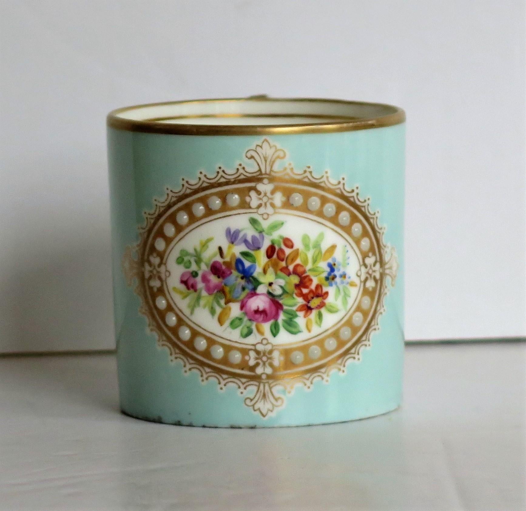 This is a very beautiful jewelled coffee can all hand painted and gilded in the French Sevres style, possibly made by them and dating to the early 19th century, circa 1810.

This coffee can is well potted and is nominally straight sided with a