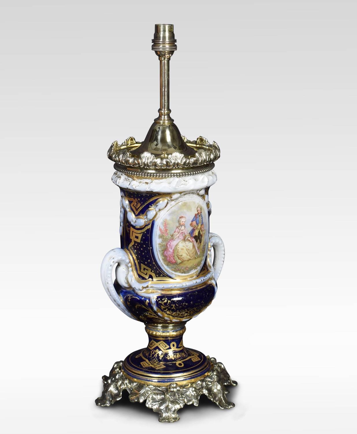 Sevres style twin handle table lamp, hand painted in cobalt blue with gold detail. Featuring a central 17th century courting couple the opposing side with floral motifs. Raised up on giltwood base. (The lamp has been rewired)
Dimensions:
Height