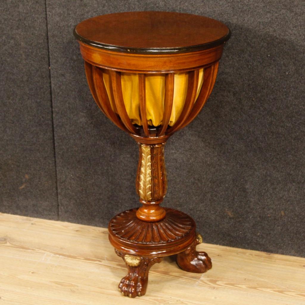 French sewing table from 20th century. Furniture carved in mahogany wood with ebonized and gilded parts of great charm. Side table supported by three zoomorphic feet, with central leg and sliding top. Good capacity interior with small compartments,