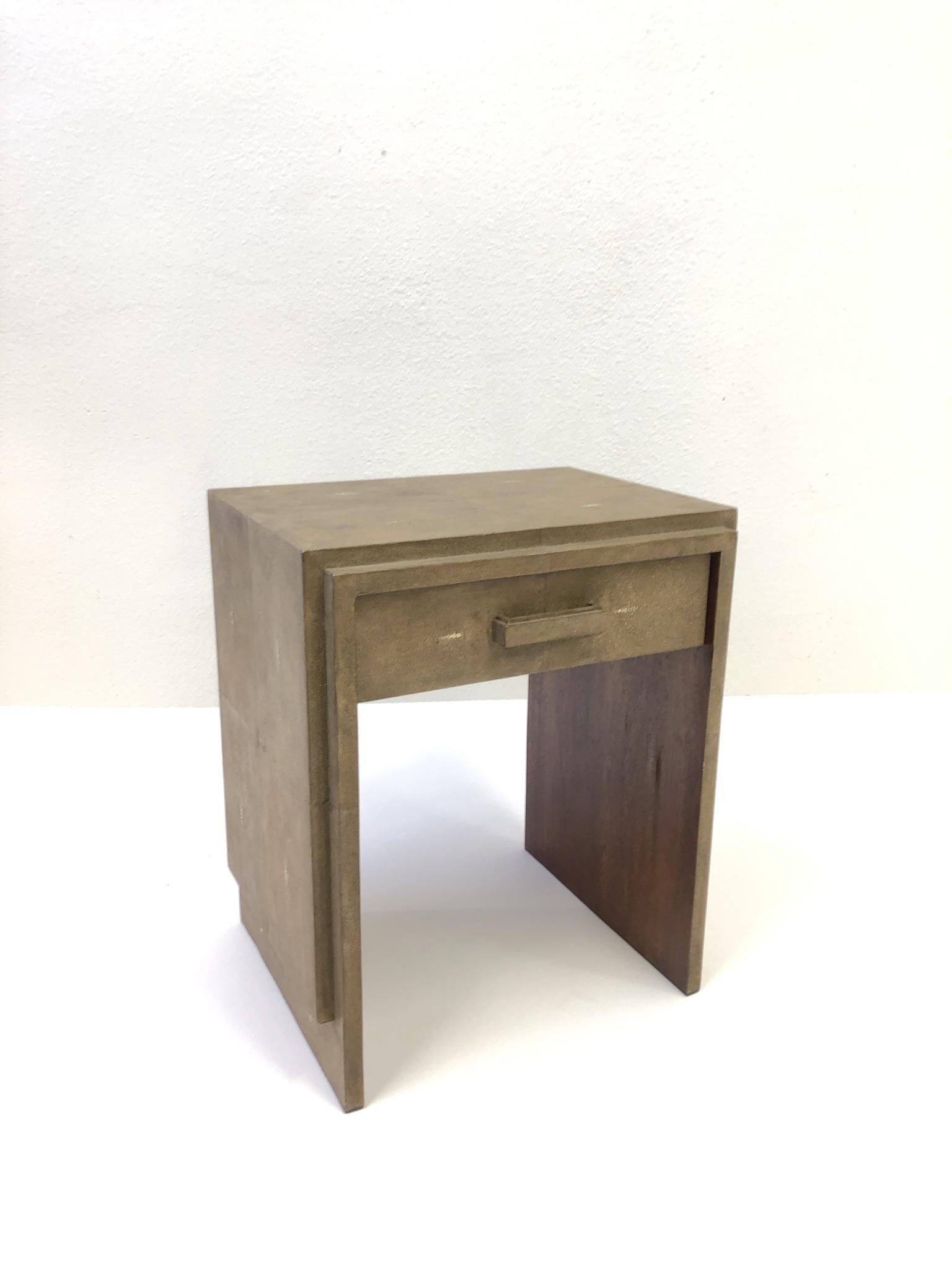 A glamorous, 1990s French shagreen and mahogany veneer side table design by Ria and Yiouri Augousti. The table has a drawer. 
Dimensions: 23.75” high 19.75” wide 15.75” deep.