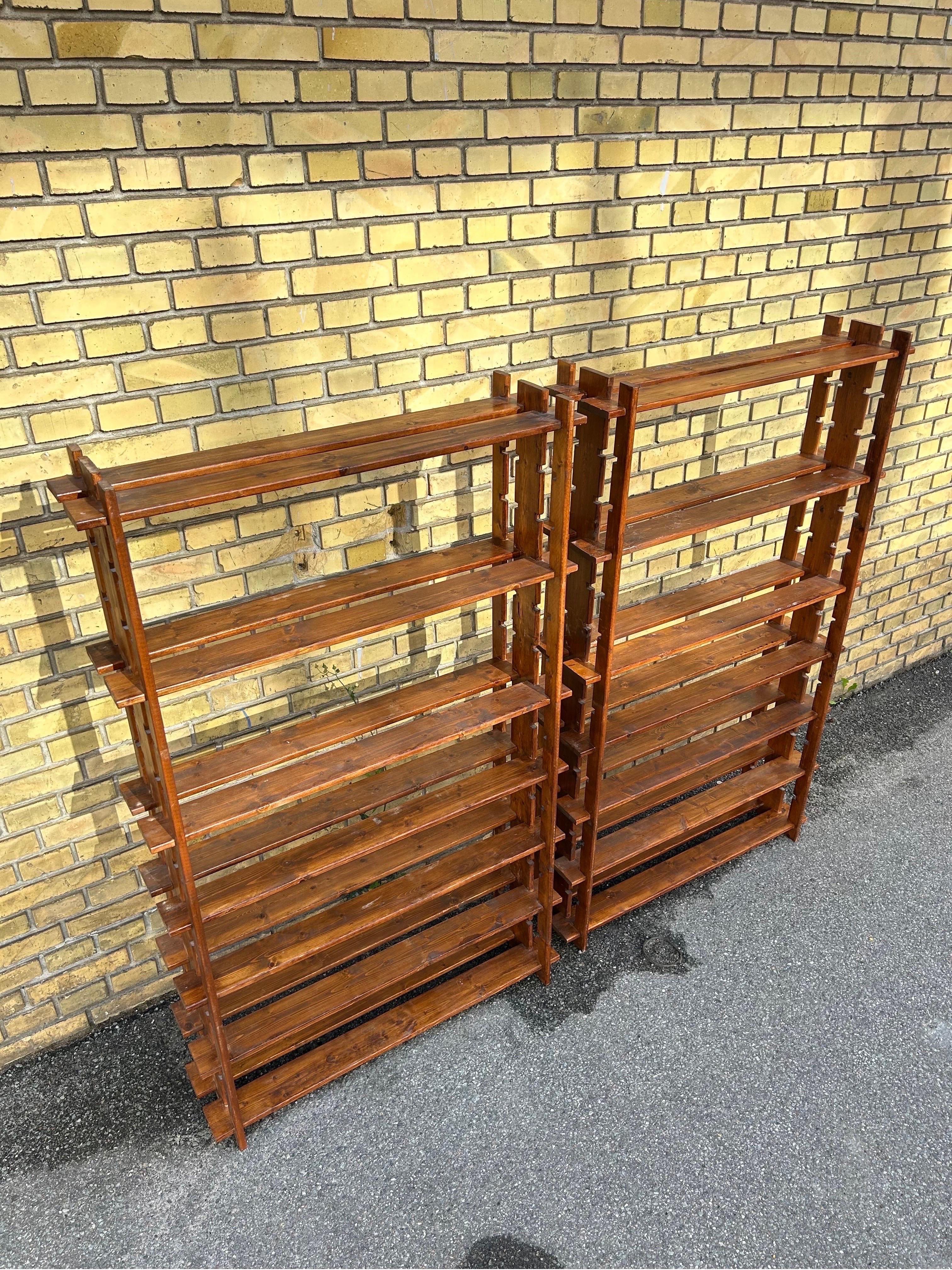 Rare pair of shelves in the style of the French designer Maison Regain, the shelves are made in France in the 1960’s in solid dark stained wood by a talented craftsman with a great eye for detail.

The shelves are in good patinaed condition with a