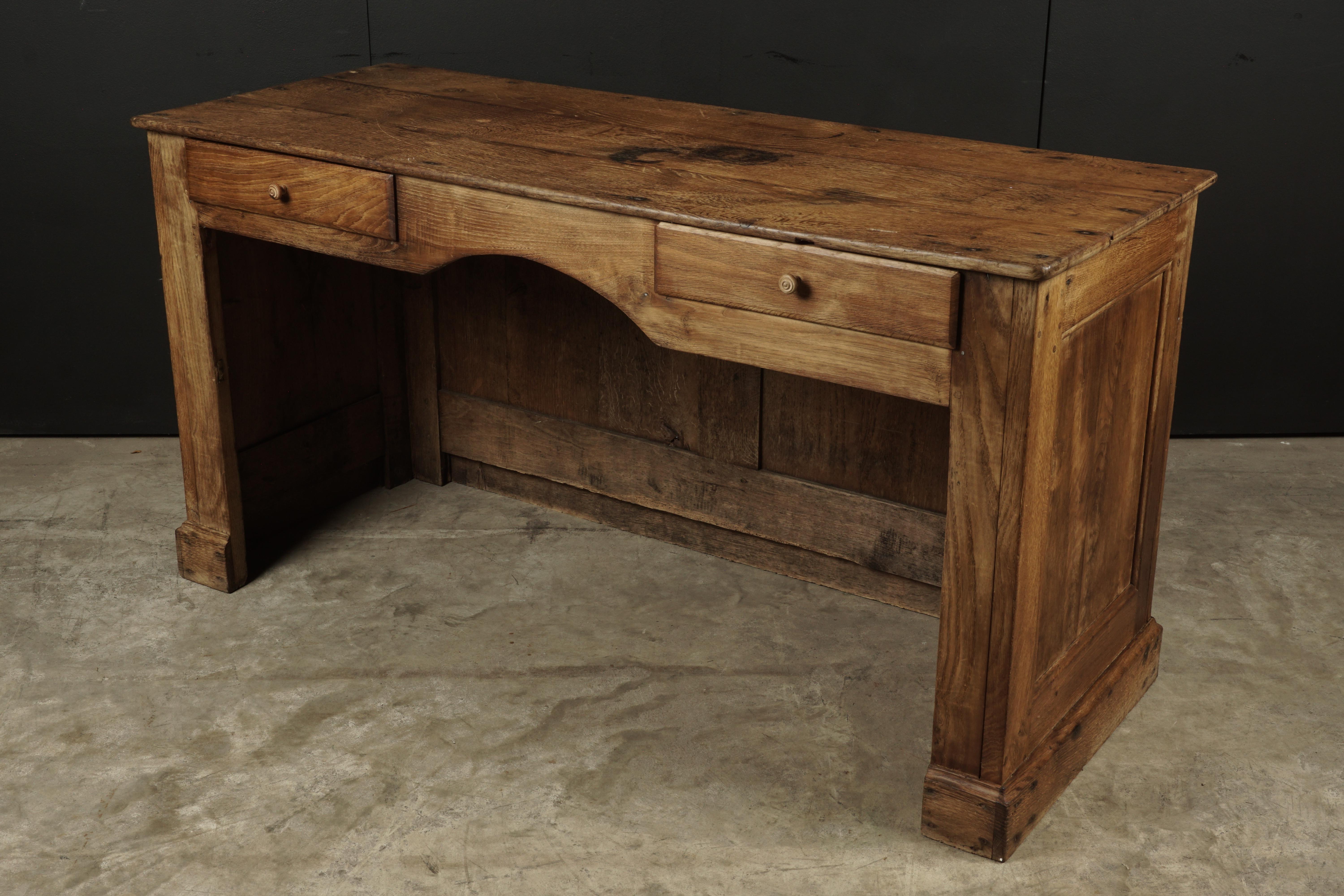 Petite shop counter in oak, France, circa 1940. Nice wear and patina. Two drawers on the reverse.
