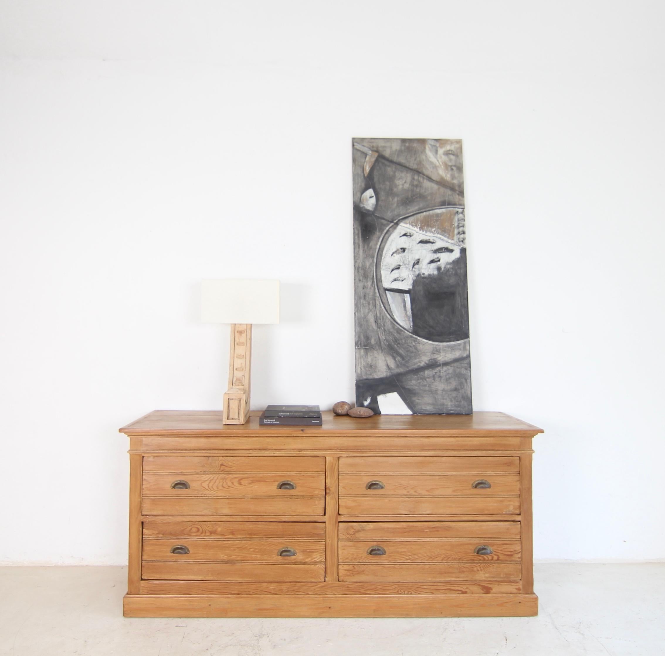 A French chest of drawers from the interior of a hat shop. Circa 1920. Solidly crafted from pine and poplar wood. Restored and ready for everyday use.

Half-height softwood body with side panels, 4 large drawers and slightly protruding top