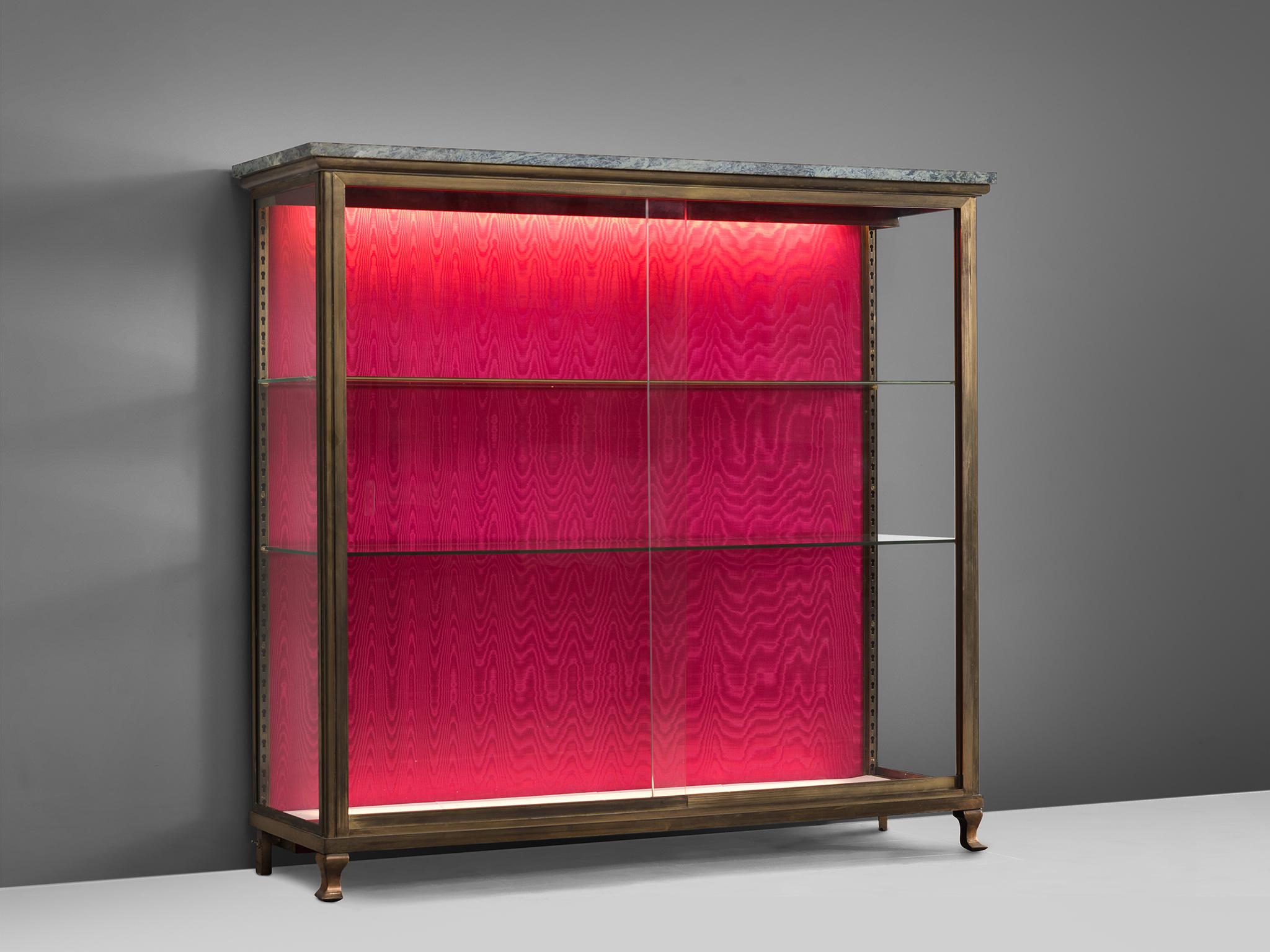 Vitrine, marble, brass, glass, silk moiré,  France, 1950s. 
 
This is a refined midcentury brass vitrine of exquisite craftsmanship, presumably made for the high-end boutique French market. This showcase is equipped with two glass shelves that can