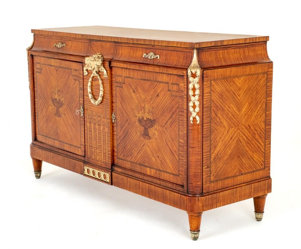 Amazing French Satinwood Side Cabinet in the Empire manner
Circa 19th Century
This Cabinet is Raised Upon Turned Feet With Brass Castors.
The Cabinet Features 2 Doors, Each Door Having a Central Marquetry Panel Featuring a Bowl of Overflowing