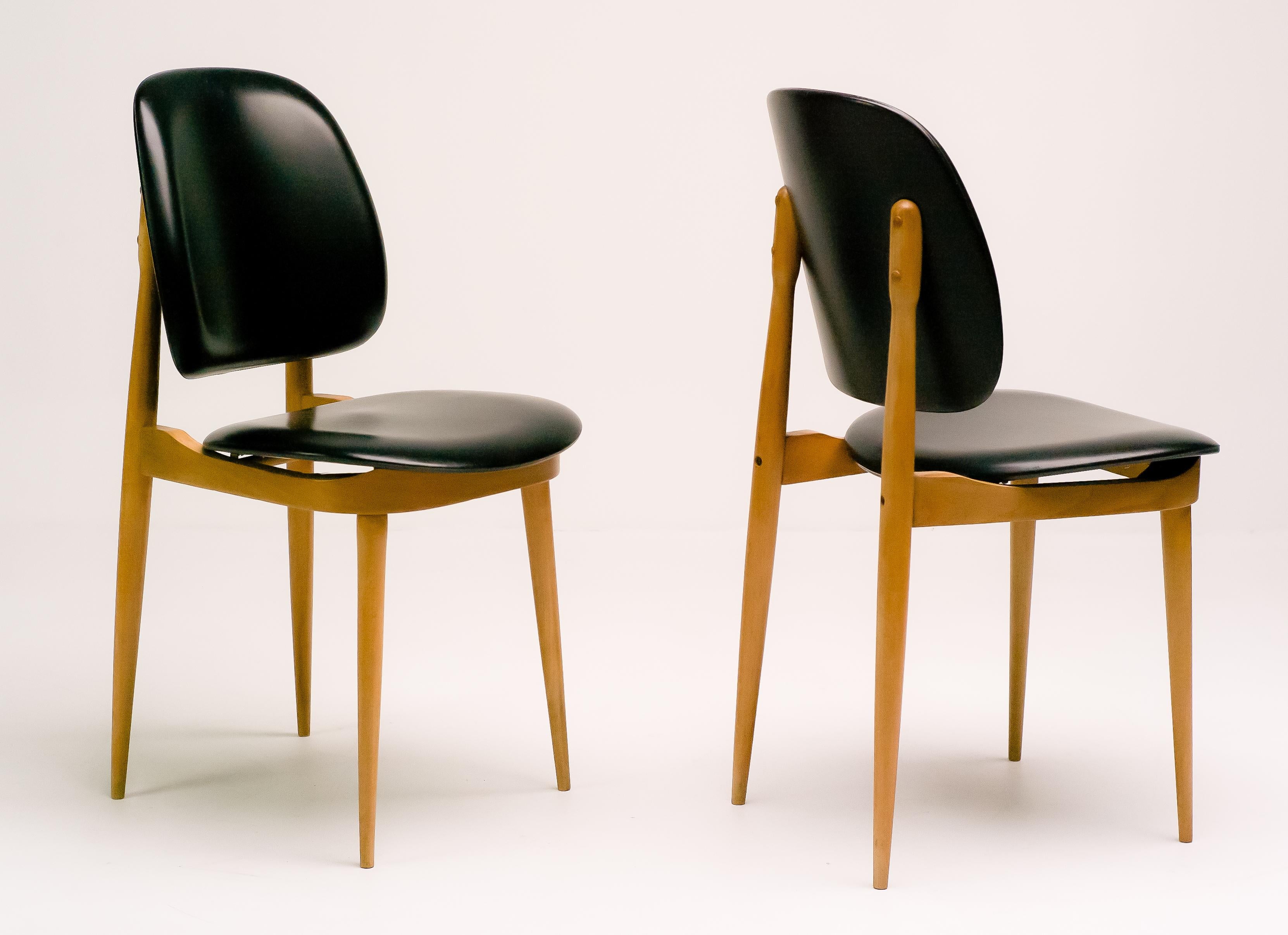 Pair of elegant chairs in maple and black vinyl.
Priced individually.