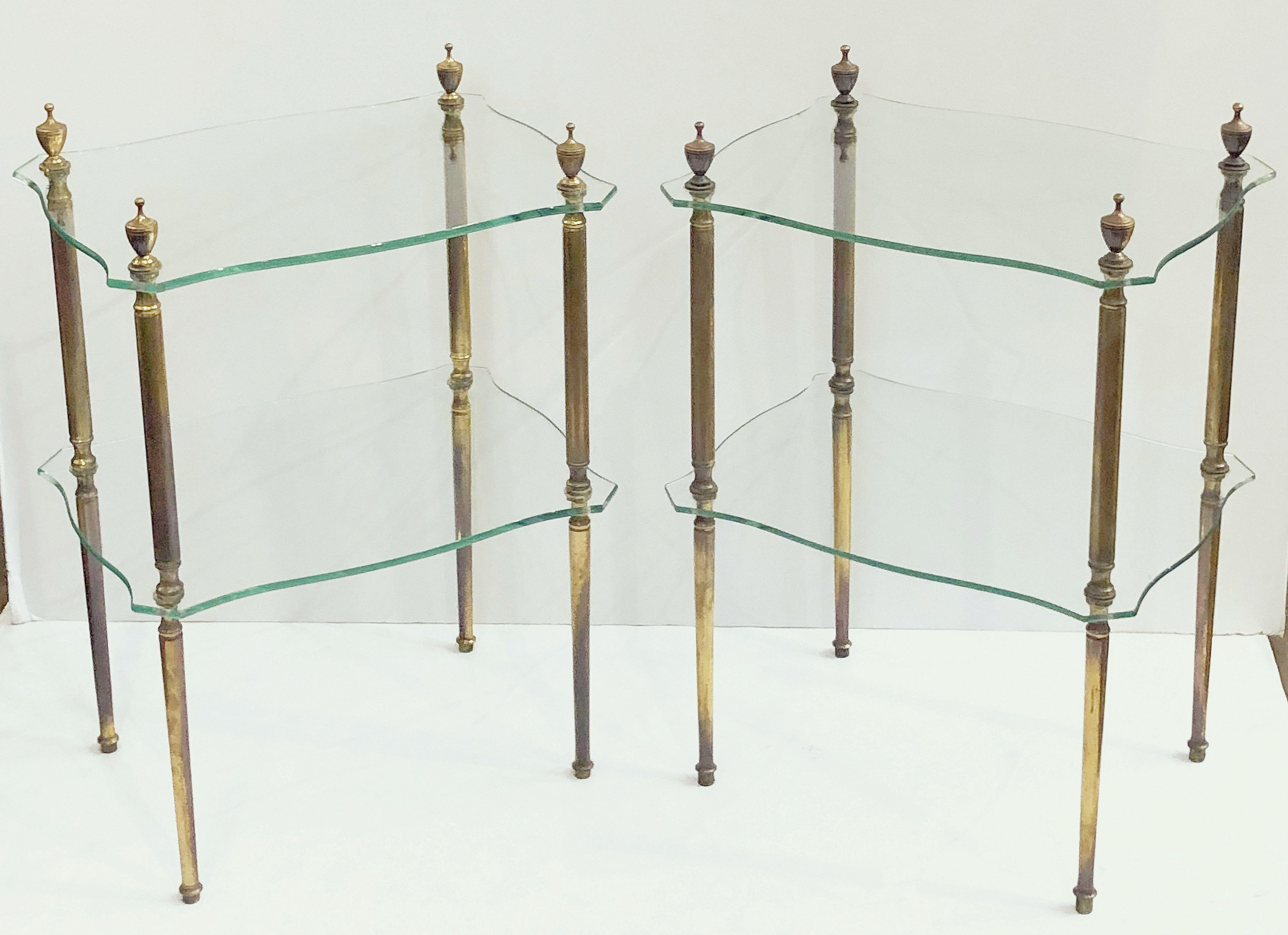 A pair of fine French two-tiered side or end tables of glass with gilt bronze legs, each table featuring two rectangular glass panels with serpentine edges, mounted to stylish supports with finial accents.

Dimensions: Height 23 1/2 inches x width