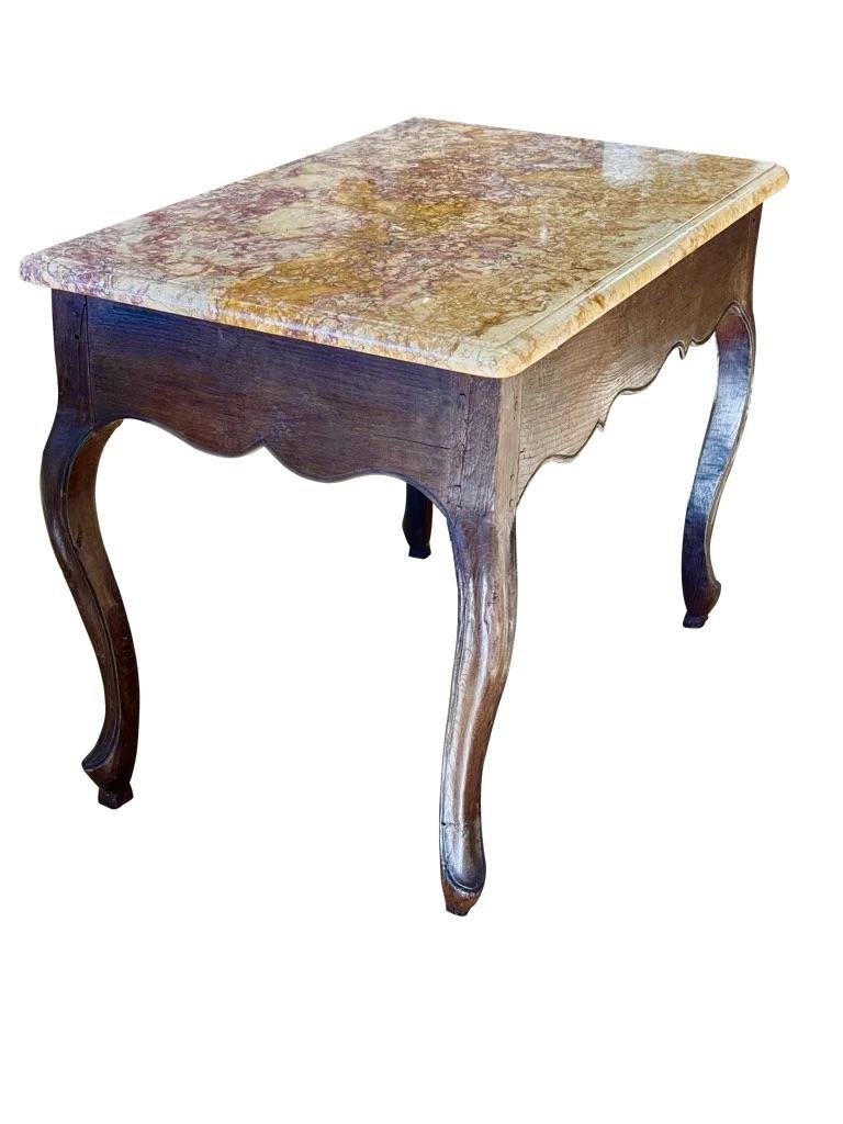 Fine 18th Century French side or center table having an exceptionally beautiful and rare Spanish marble top in deep fuchsia purple and yellow.                            

