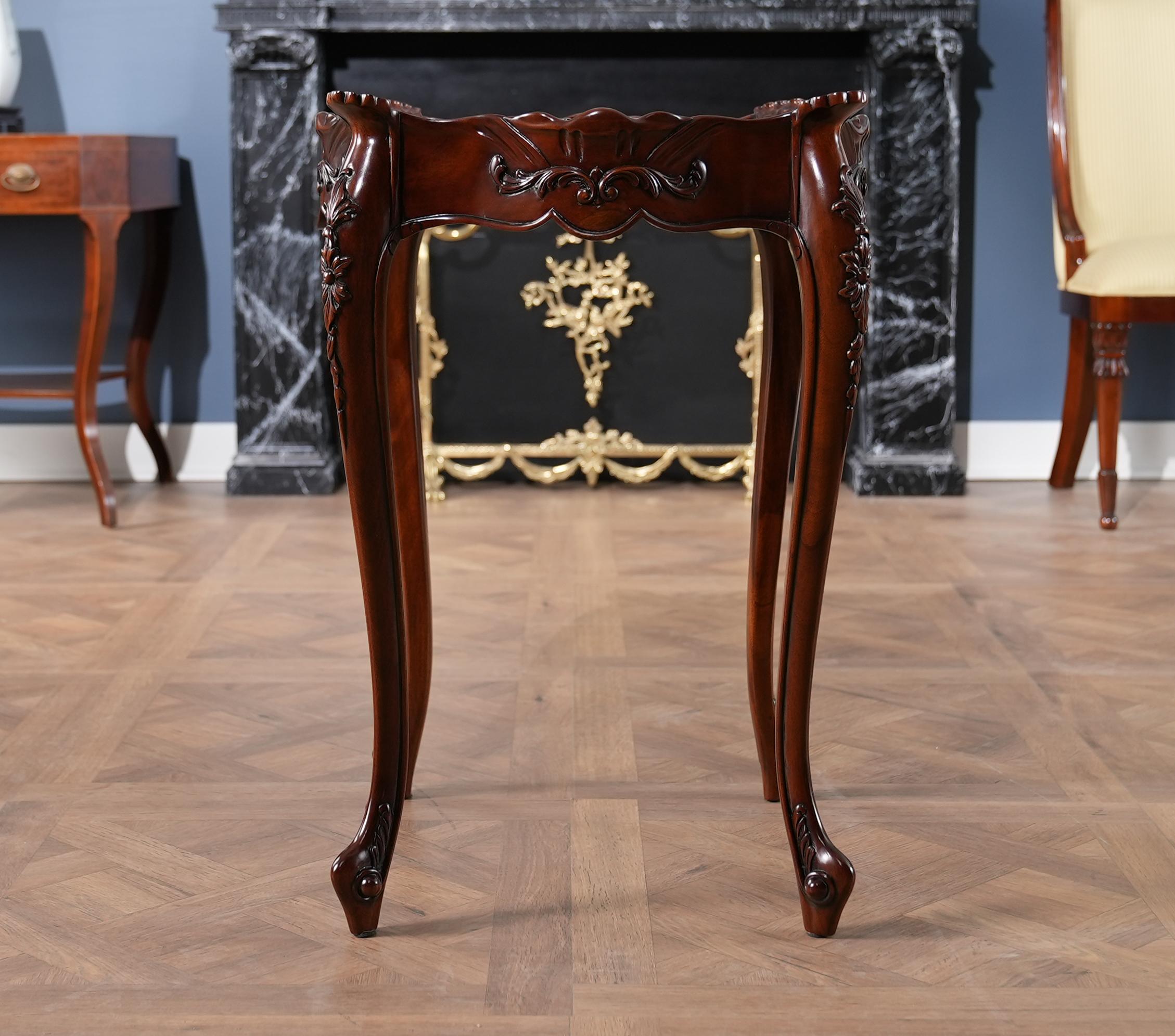 Designed after a 20th Century Classic this French Side Table is a high quality antique reproduction which features fantastic hand carved details all the way from the molding along the top of the table down to the solid mahogany French styled feet.