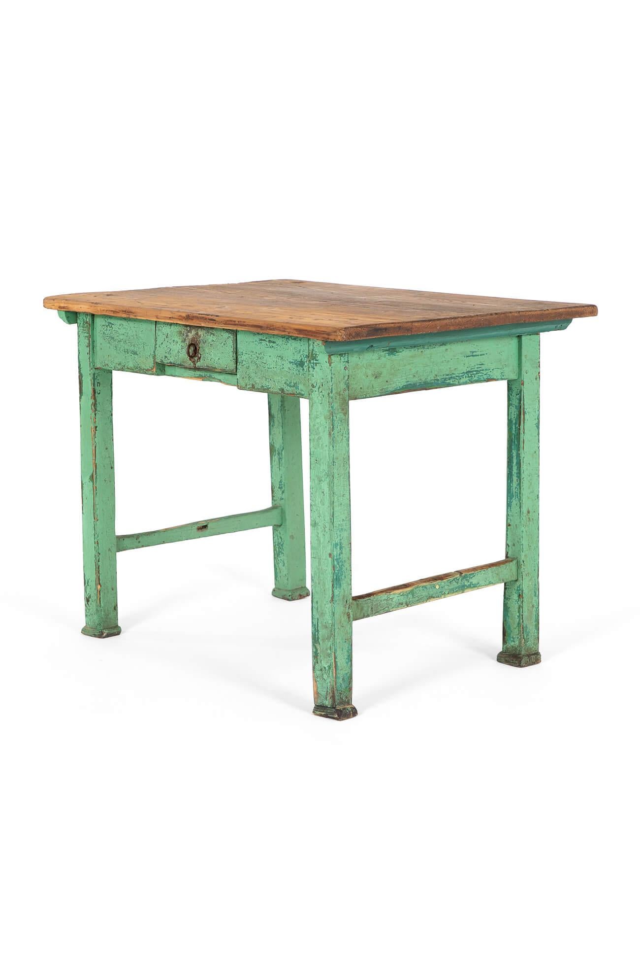 A charming small side table with a central drawer and original key.

The weathered pine top sits upon a carved painted green base with stretchers at either end.

All raised on block legs and pad feet.

French, circa 1900.