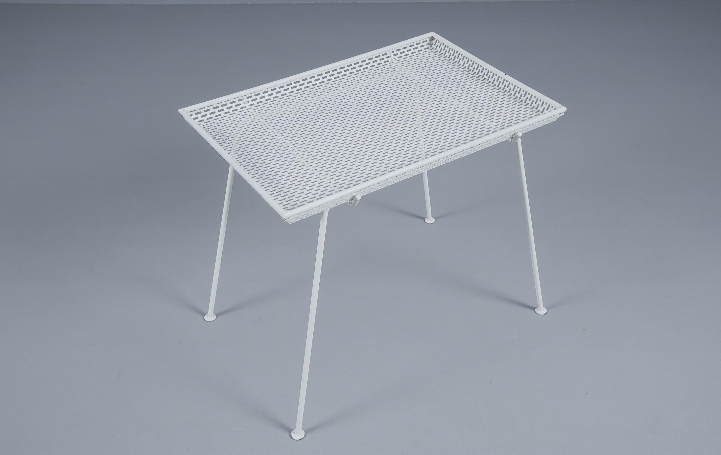 French side table in perforated white lacquered metal with removable tray, 1950s.

Overall good to very good condition with normal light signs of use due to age.