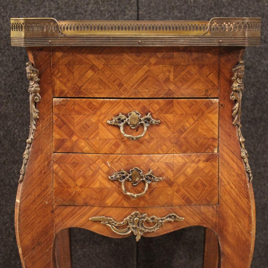 A beautiful French side table inlaid in rosewood, 20th century. 

French side table from 20th century. Furniture adorned with geometric inlay in rosewood with chiseled brass and bronze decorations. Night stand equipped with two front drawers and