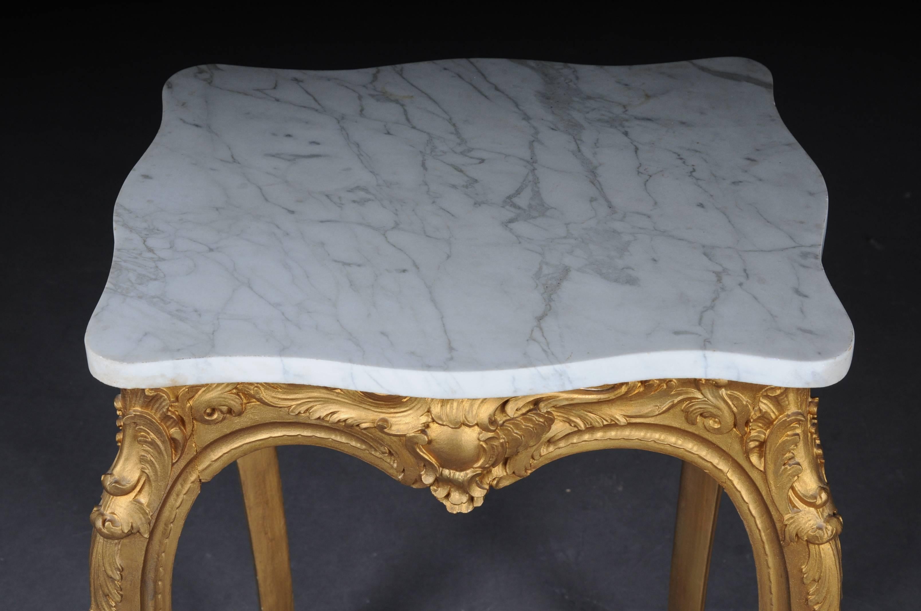 Body completely set in gold. Carved frame ends with long curved legs. White mottled marble top.


(G-72).