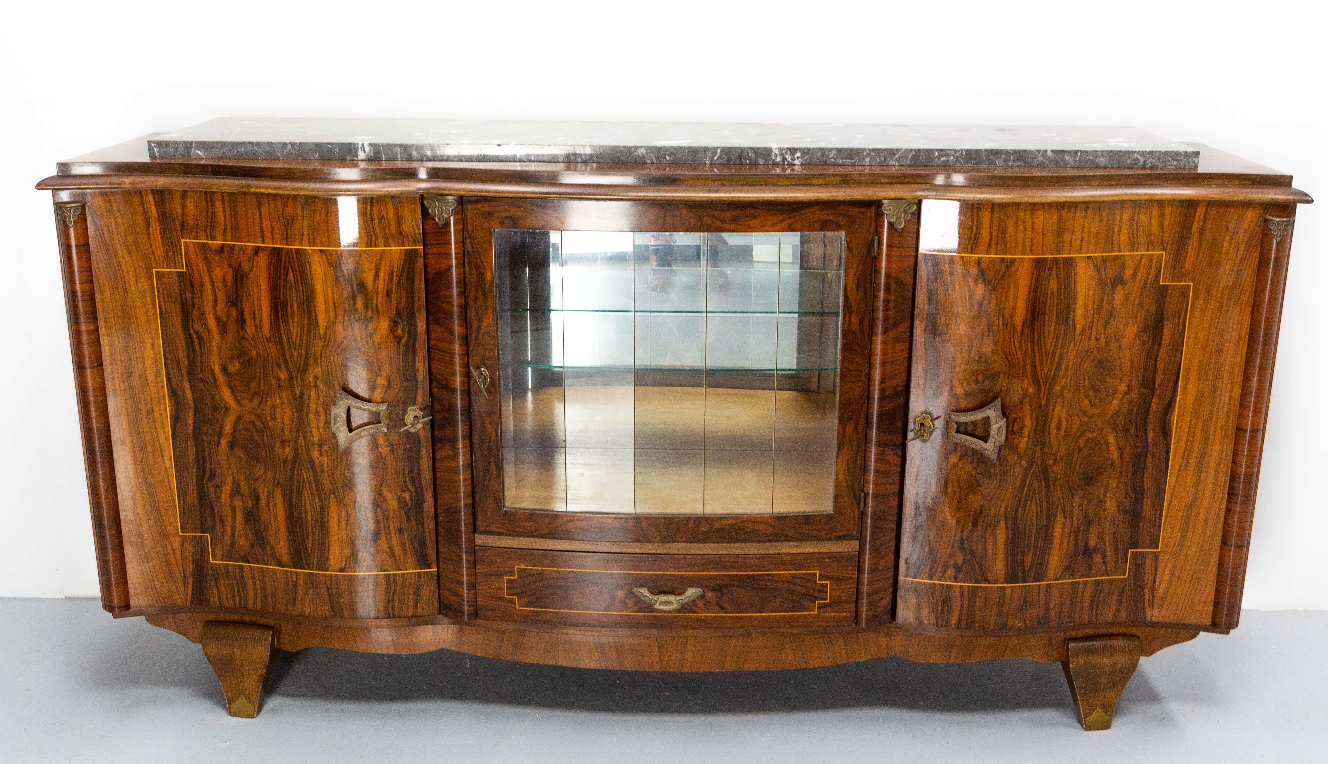 Mid-century characterful credenza sideboard French buffet circa 1950-1960
Walnut burl, solid marble and brass.
Each part of brass is worked with care.
The beveled glass door is made of five glass plates.
Marquetry nets on the shelves
