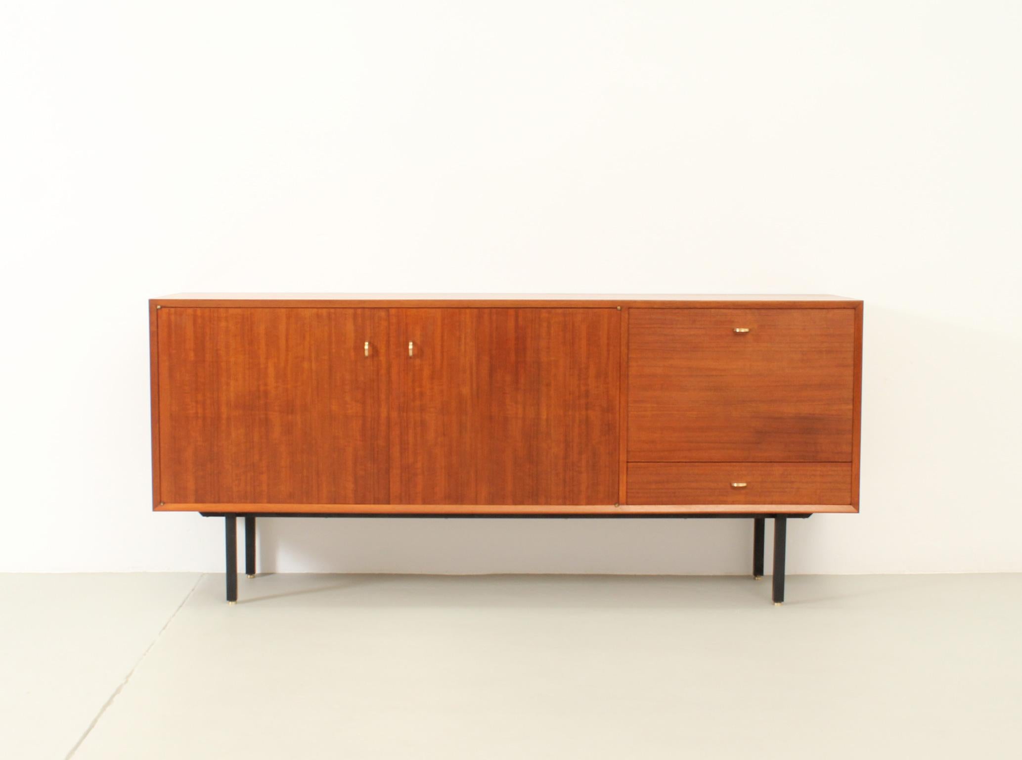 Teak sideboard from 1950's, France. Teak wood and maple interior with black metal base and brass fittings.