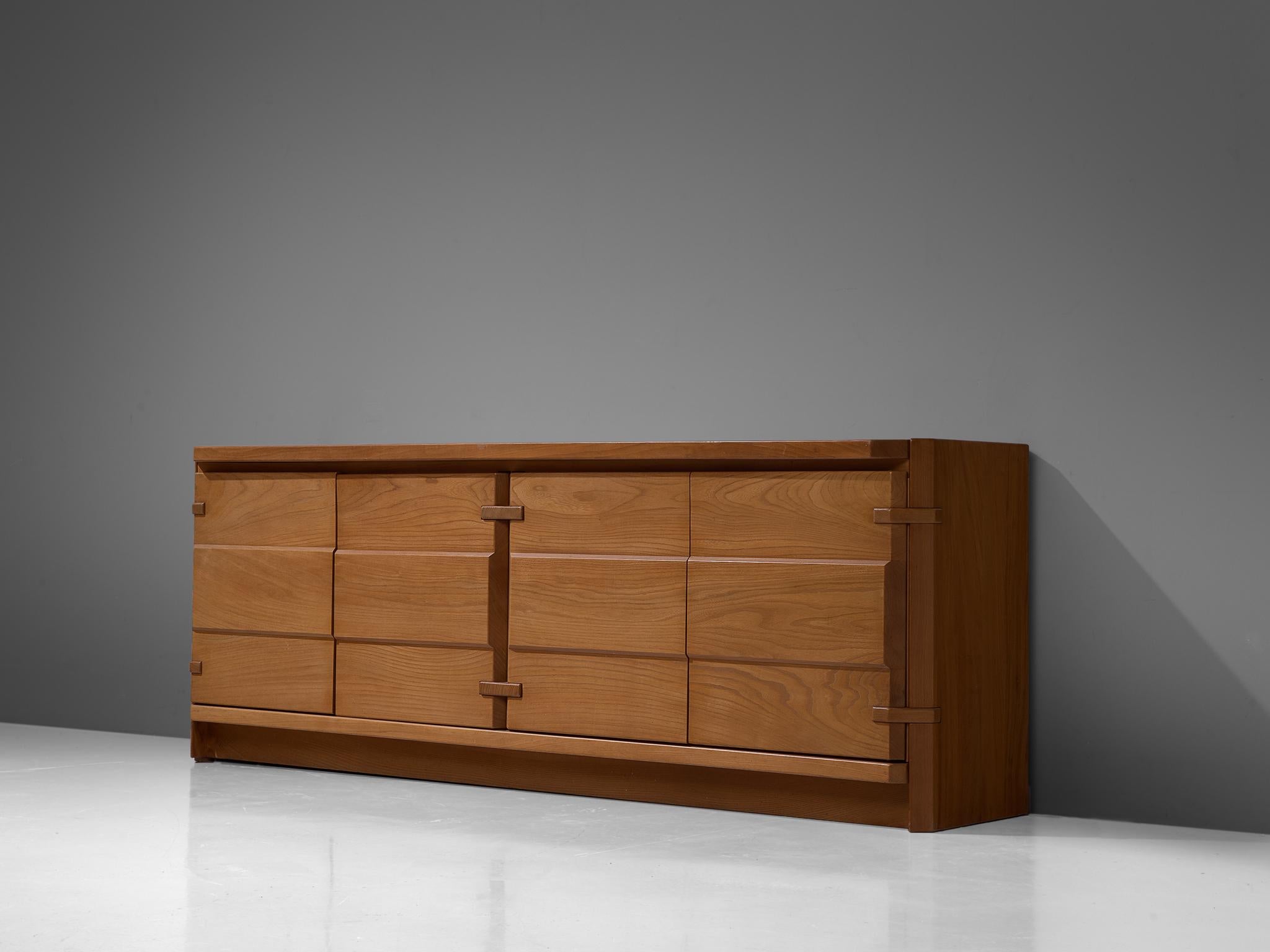 Sideboard, elm, France, 1980s

Angular sideboard from France in the style of Pierre Chapo. The credenza seems to be completely executed in elm, even the joints visible on the outside are made of wood. The doors show a sutle structure that reminds