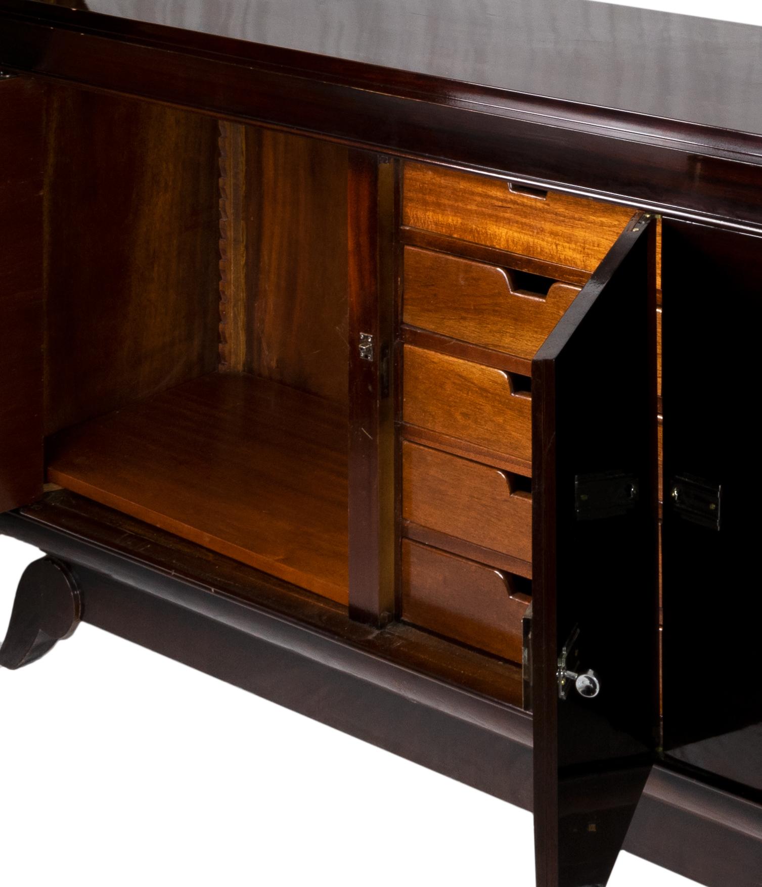 Long sideboard with dark lacquered doucine veneer finish, nickeled door handles, three doors and internal cedar wood drawers. 

Four large interior drawers for dinnerware and cutlery in the middle section. 
Ready to be in service once