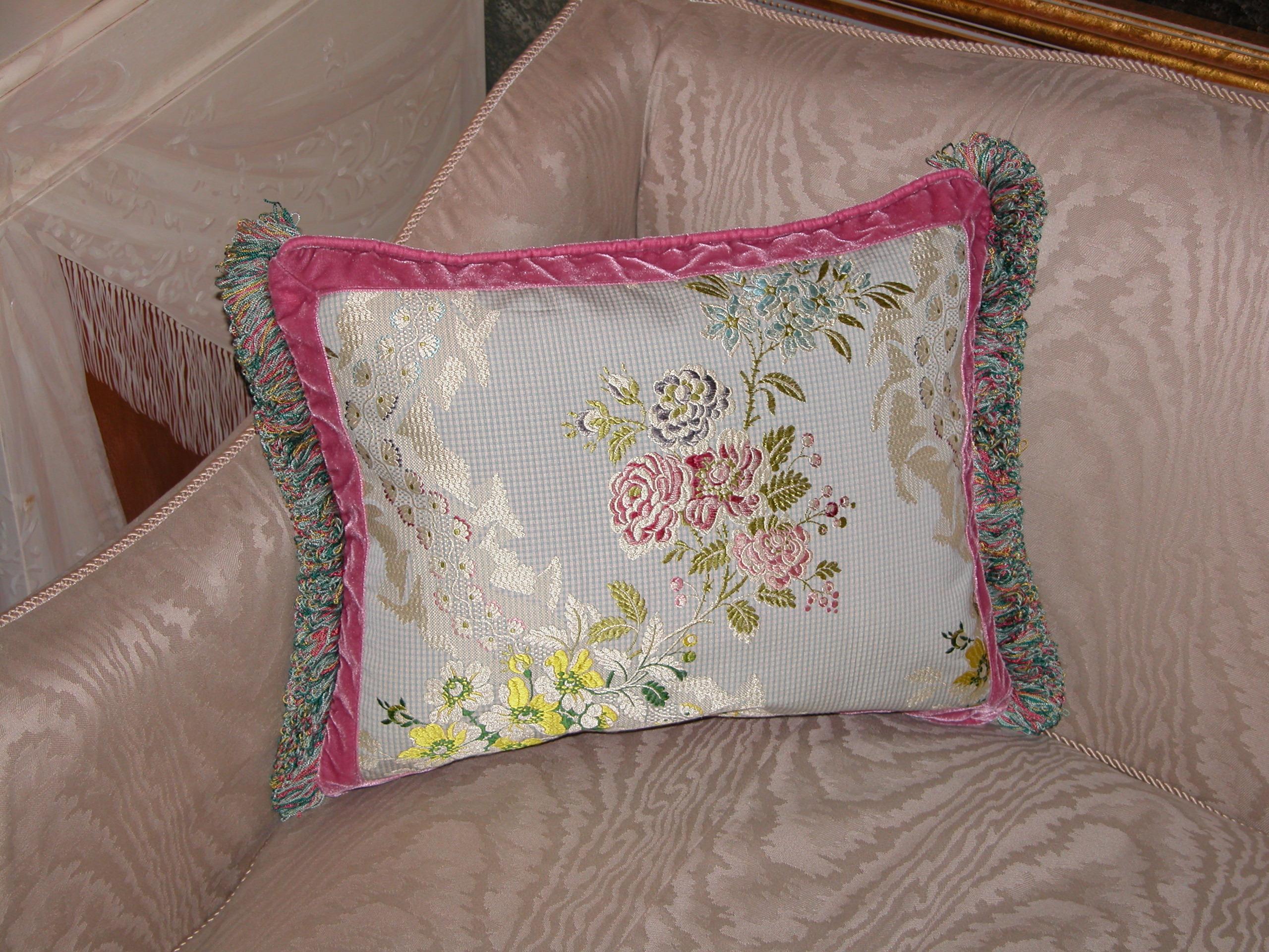 Throw pillow made from a French silk brocade woven in the 1990s, likely by Old World Weavers. Measures 13 inches x 17 inches. The trims include a silk velvet flat trim and a loop fringe by Passementerie, Inc.