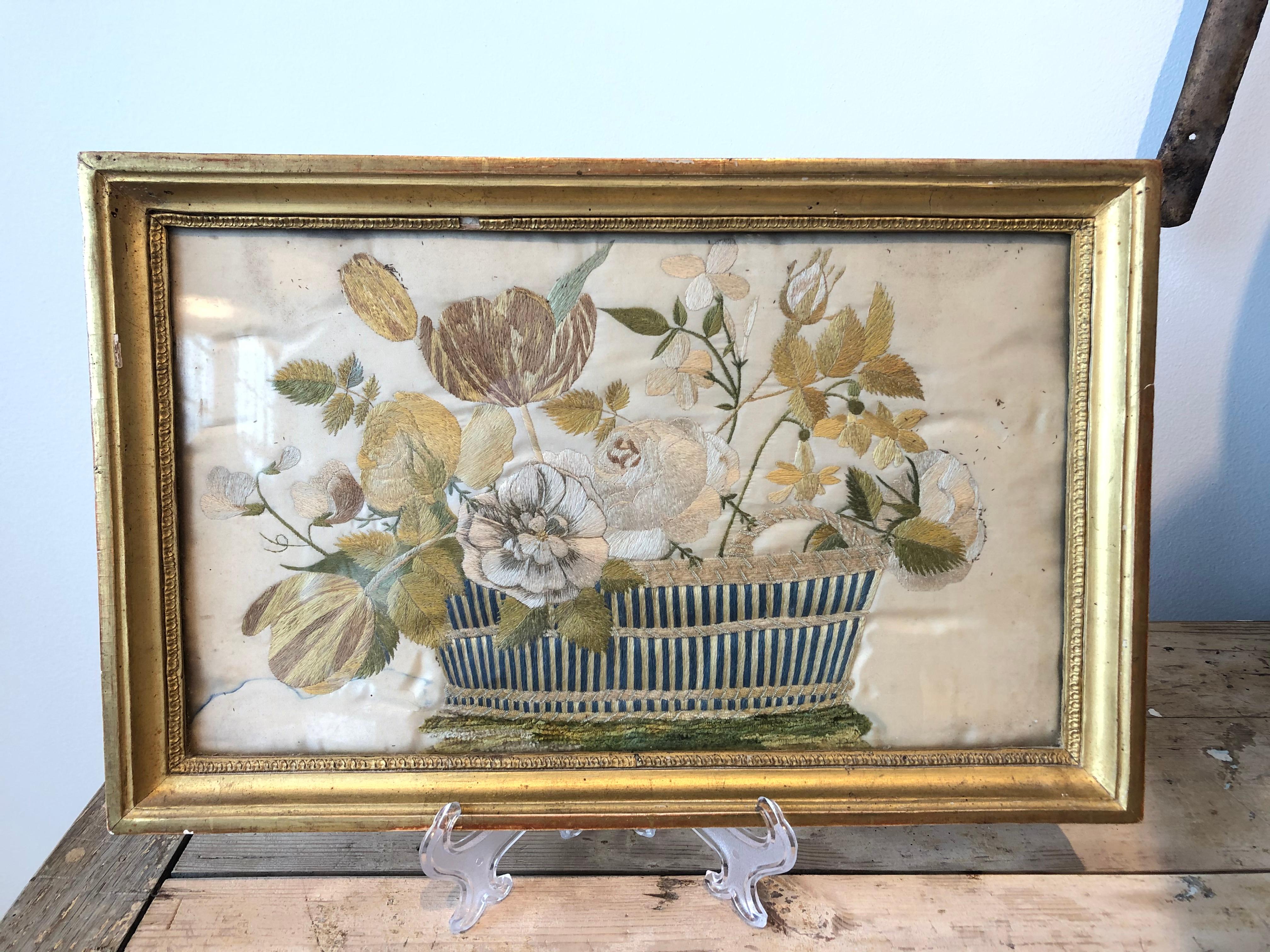 French silk needlepoint of flowers in basket in gilded frame.