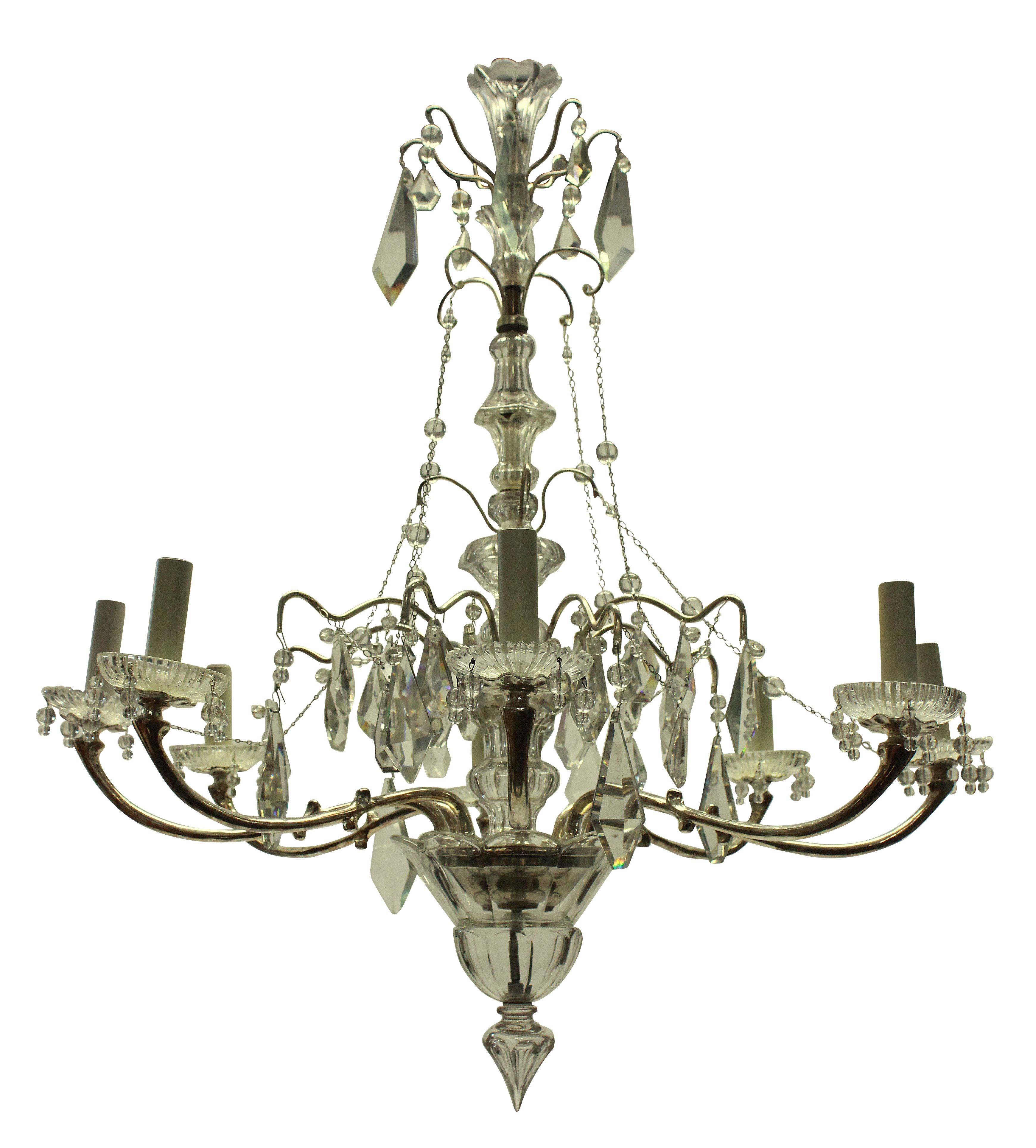 A French silver plated and cut glass chandelier of six arms. Hung throughout with finely cut plaques, chains and beads, with a crisply cut central baluster stem and finial.