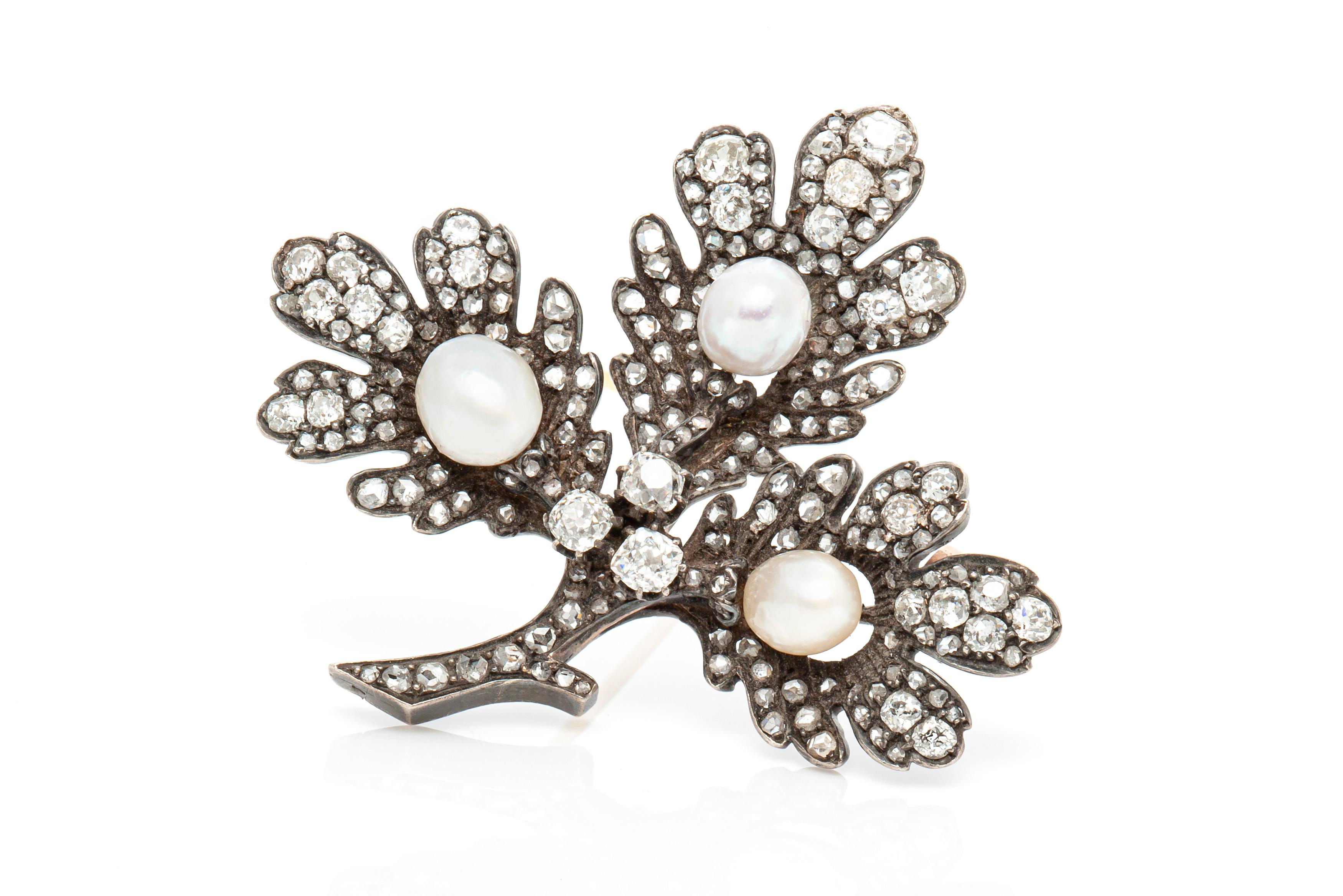 The brooch is finely crafted in silver and gold with pearls and diamonds weighing approximately total of 9.50 carat.
