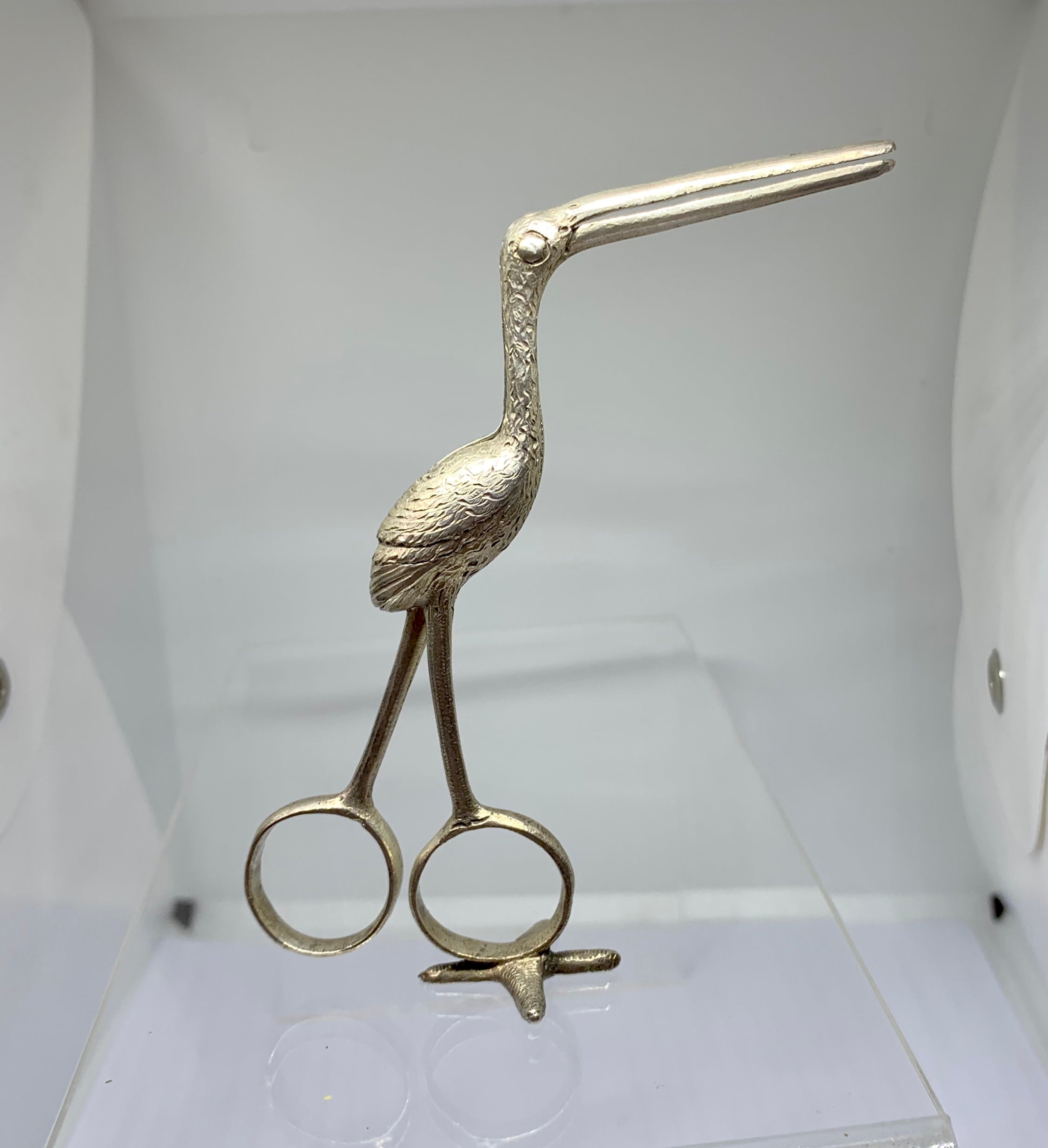 This is a rare pair of antique 19th Century Silver Birth Announcement Stork Scissors with a swaddled baby infant in the body of the stork.
The Silver birth stork scissors served as a birth announcement and were used to cut the umbilical cord. The