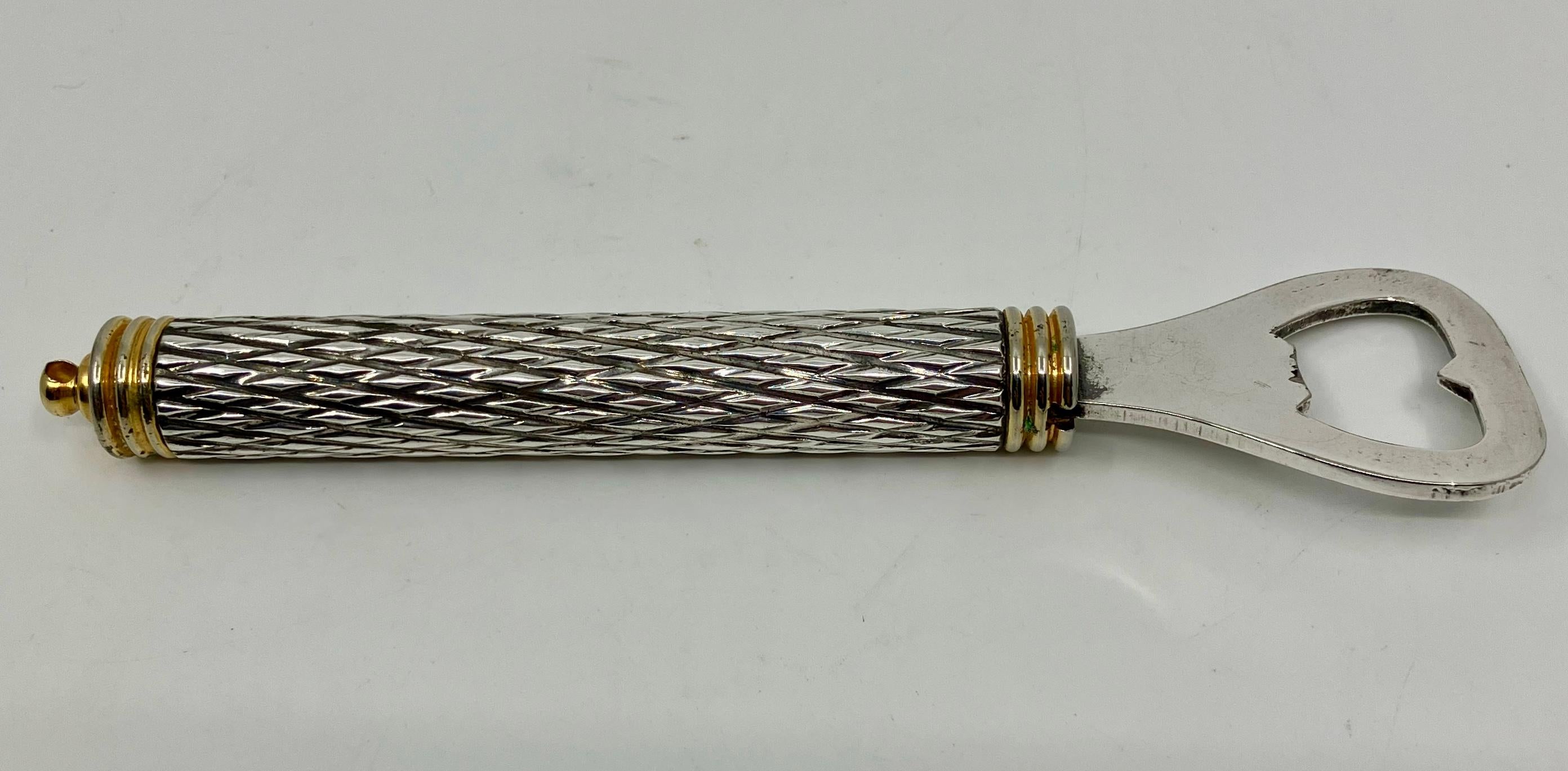 French silver bottle opener. Silvered and gold metal bottle opener with harlequin diapered engine turned cylinder. France 1930’s

Dimensions: 6.38