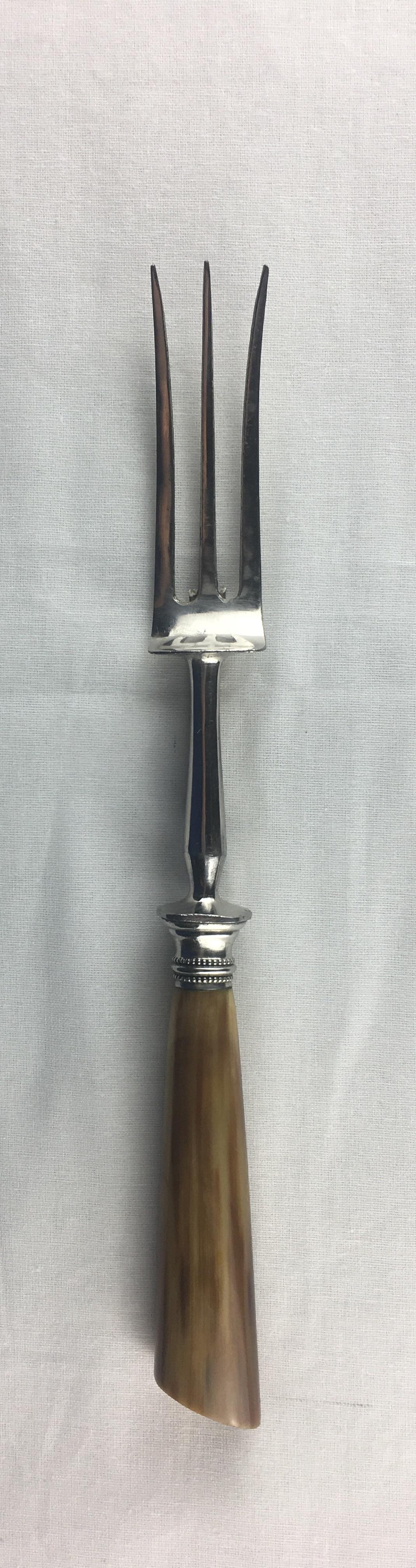 French horn, silver and stainless steel carving service comprising a knife, a fork and a handle for holding a leg of lamb all with bone tines. 
Good condition consistent with age, some minor darkening due to use. 
Original box included, measures