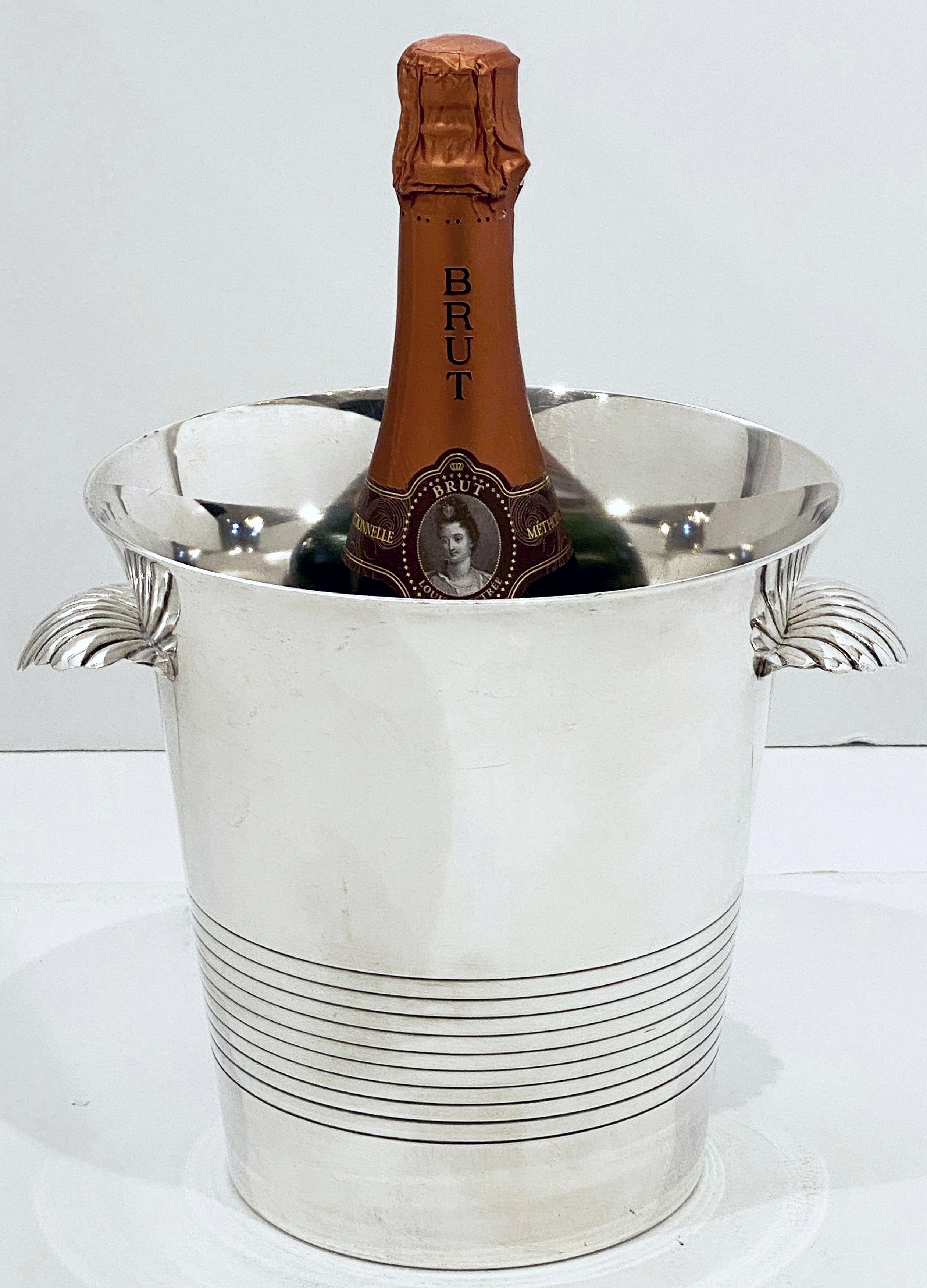 A French champagne bucket or wine cooler of fine plate silver, featuring a flared edge top, two stylish opposing handles with a shell motif, and an elegantly tapering body.

Impressed hallmarks on base.

Dimensions are

H - 8 inches
Diameter