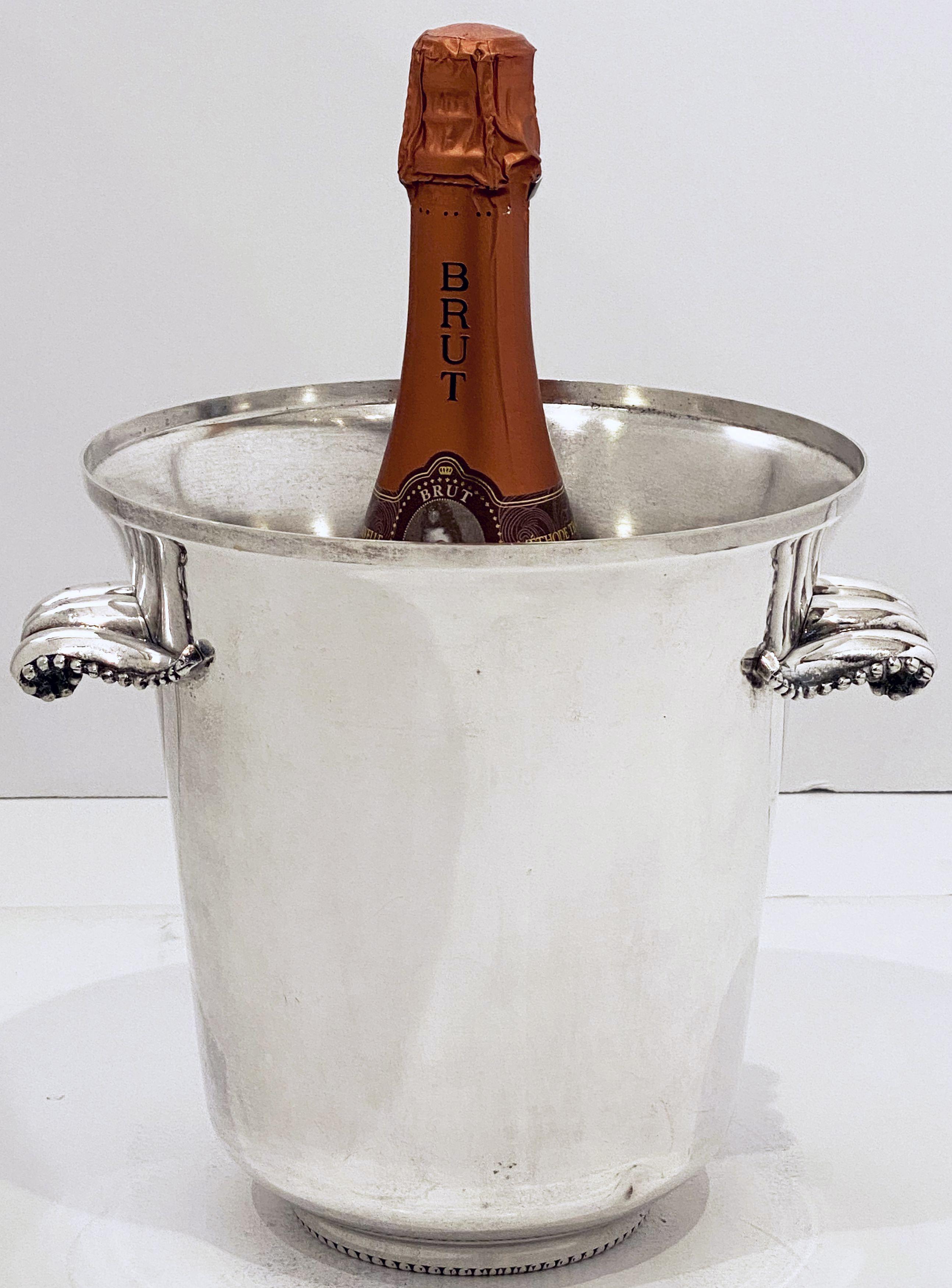A French champagne bucket or wine cooler of fine plate silver, featuring a flared edge top, two stylish opposing handles, and an elegantly tapering body. 

Impressed hallmark on base.

Dimensions are 

H - 8 1/4 inches
Diameter of opening - 8