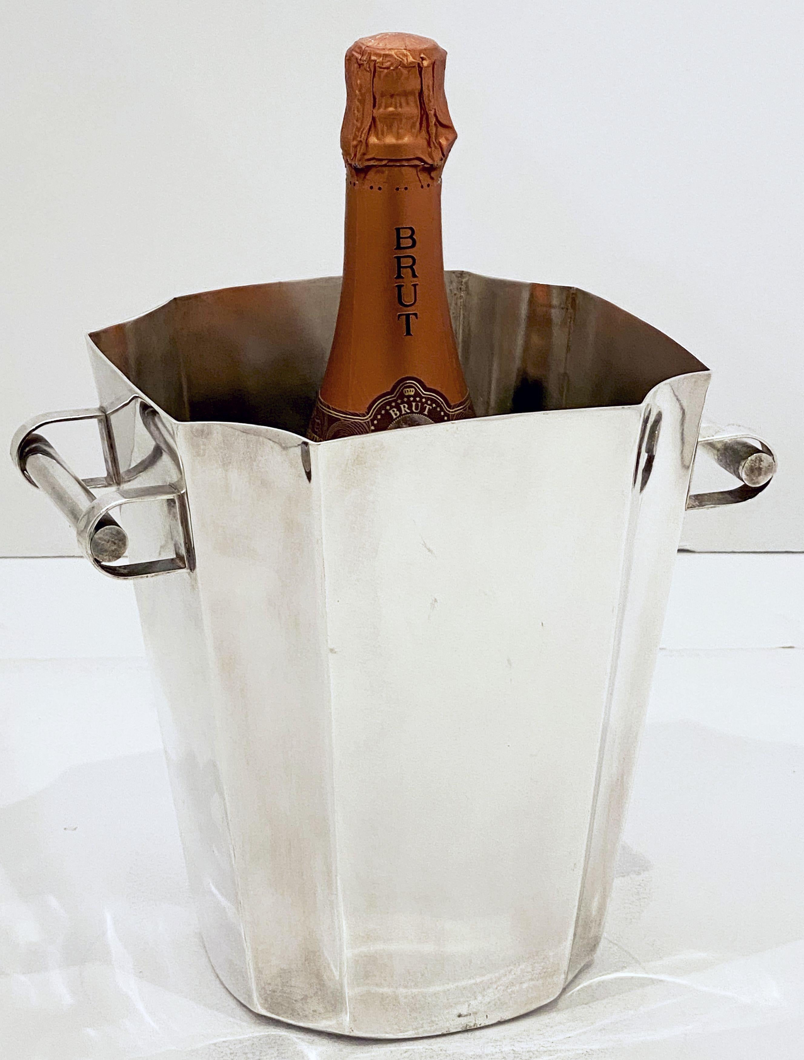 A French champagne bucket or wine cooler of fine plate silver in the Art Deco style, featuring a flared edge top, two stylish opposing handles, and an elegantly tapering body with canted corners.

Impressed hallmarks on base.

Dimensions
