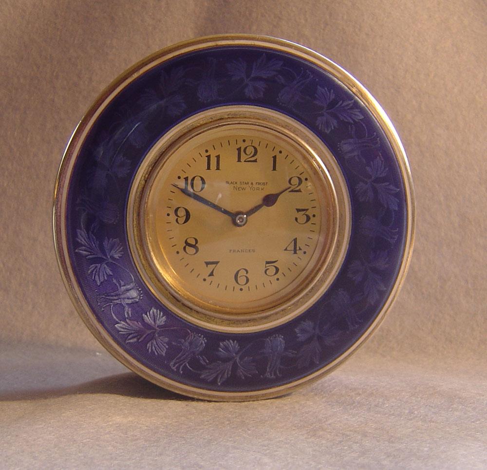 A most unusual and quite beautiful, large silver gilt and florally decorated French blue guilloche enamel box clock. The circular box with engine turned silver gilt base with bands of silver and white enamel with a wide floral guilloche enamel band