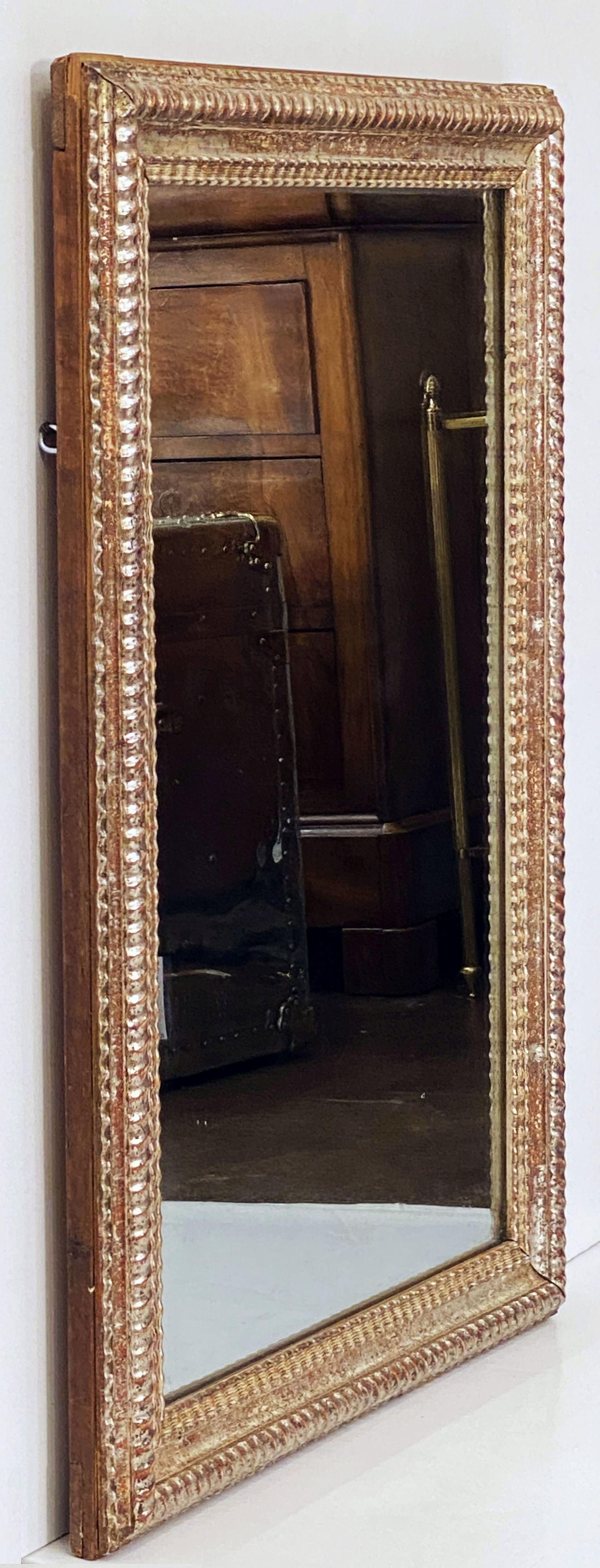 A fine French silver gilt rectangular mirror from the Louis Philippe Era featuring a ripple edge silver giltwood frame.

Can be hung vertically (portrait) or horizontally (landscape).

Dimensions are H 34 inches x W 24 5/8 inches.
