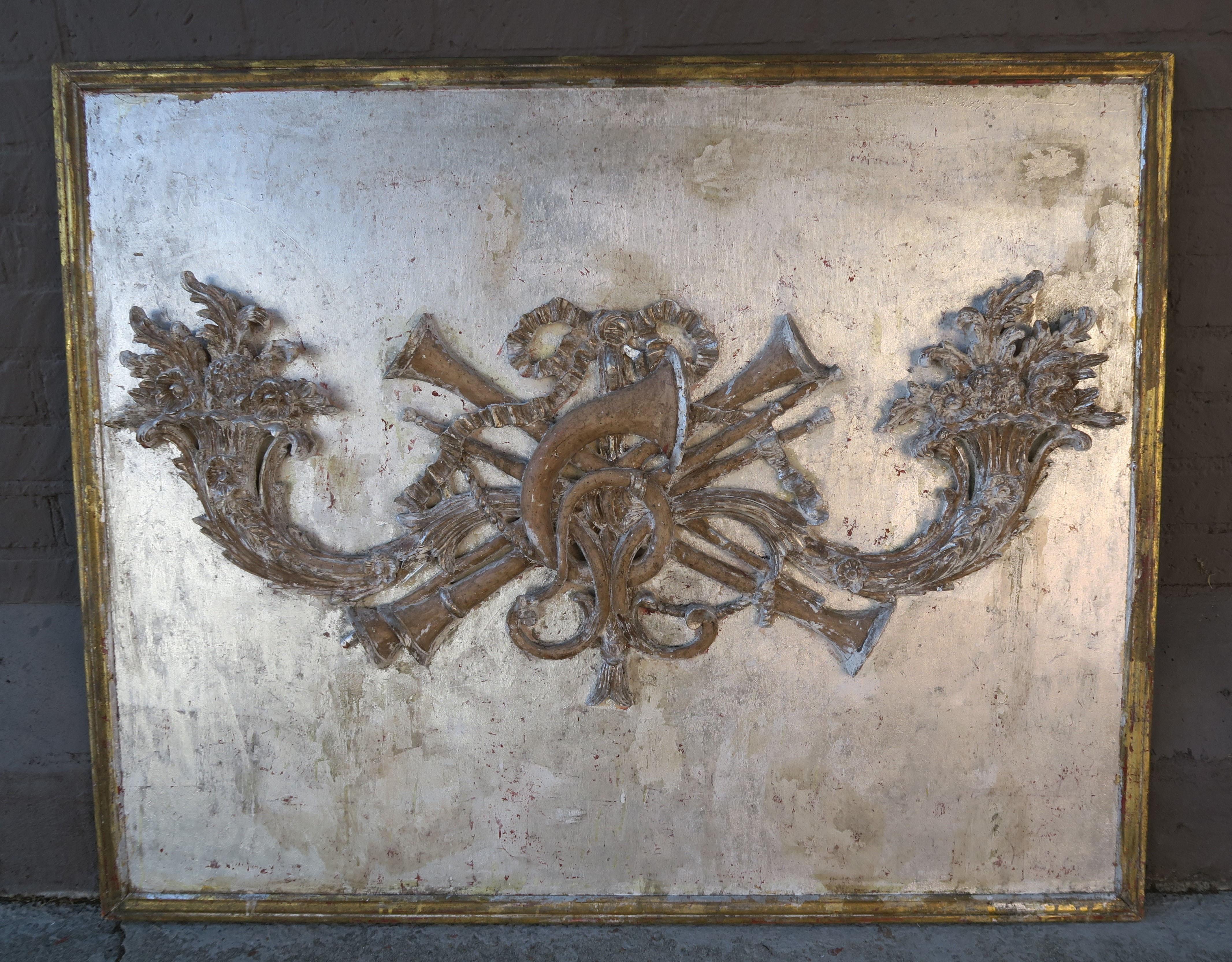 French silvered carved wood double cornucopia panel framed in a gold leaf finish. The panel is beautifully detailed with musical instruments, ribbon, flowers, and so much more. It could be made into a magnificent headboard or be hung on a wall as