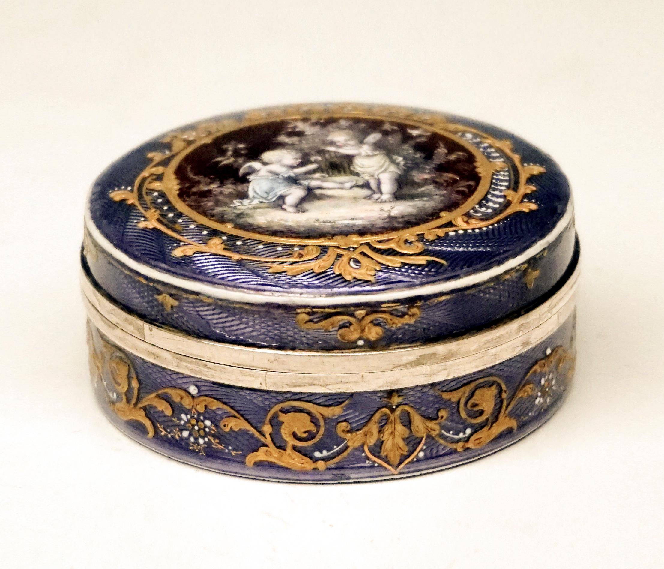 Exquisite enamel box from The Period circa 1900

Round silver box, completely guilloché and violet enamelled with a red medallion on the lid. Finest delicate enamel painting - cherub and elfin with bird cage in natural surrounding, as well as