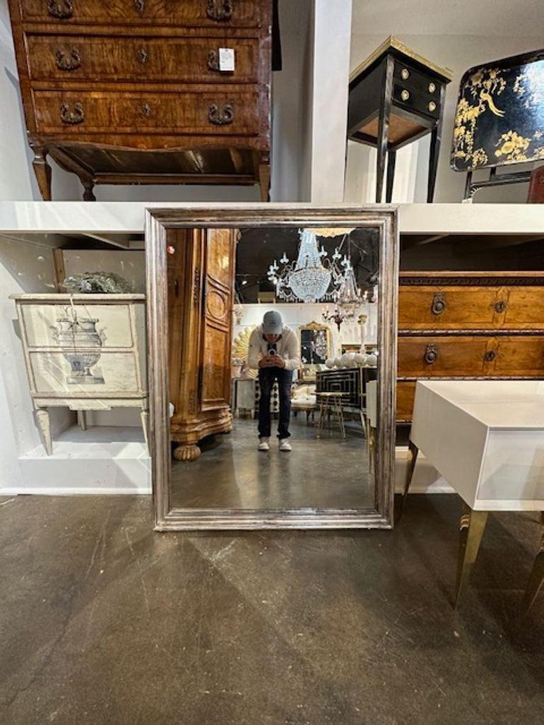 19th century French transitional silver leaf wood mirror. Circa 1880. Sure to make a statement!