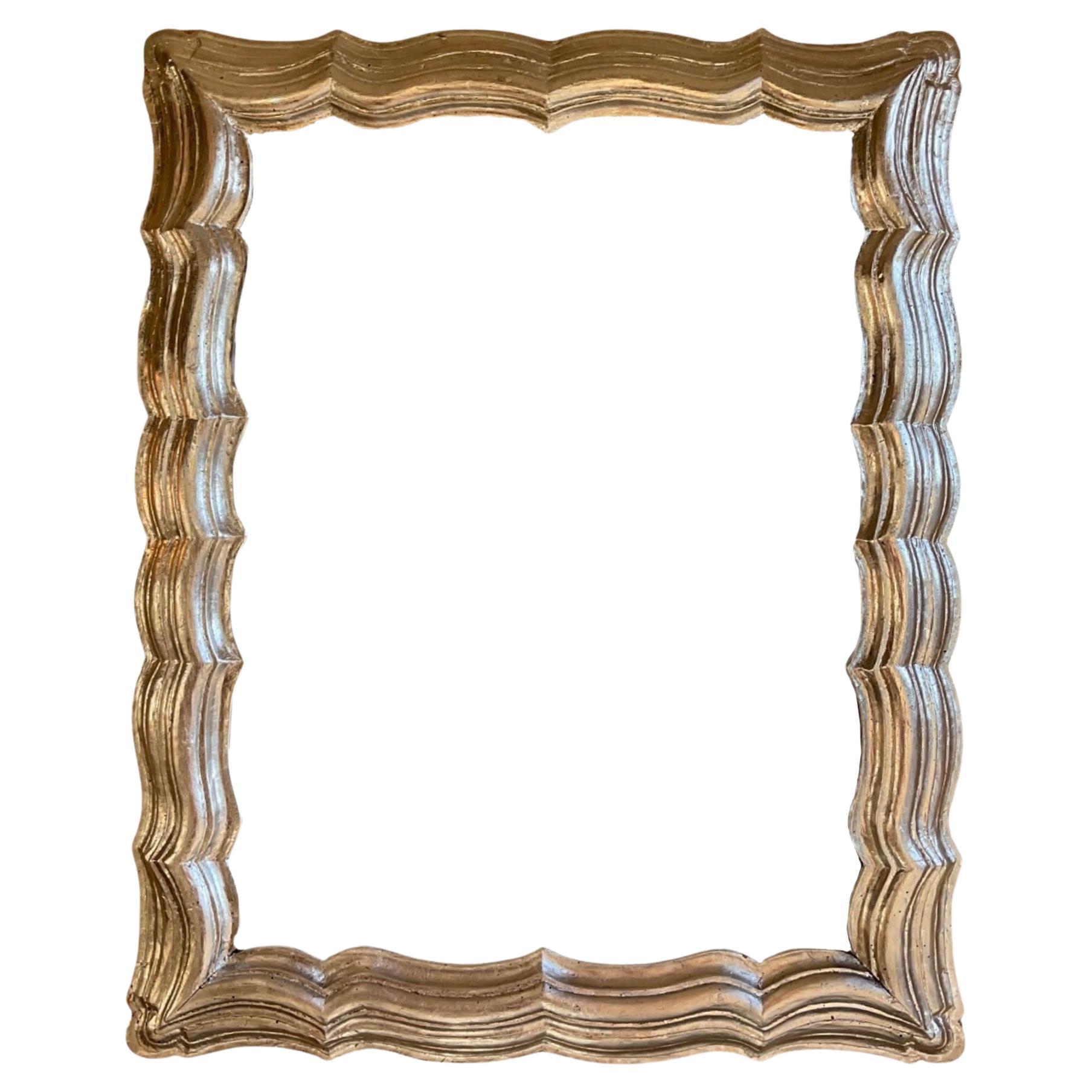 This 19th-century French Silver Leaf Oakwood Mirror radiates elegance with its silver leaf finish and sturdy oakwood construction. This authentic piece adds a touch of sophistication to any space, making it a timeless investment for your home.