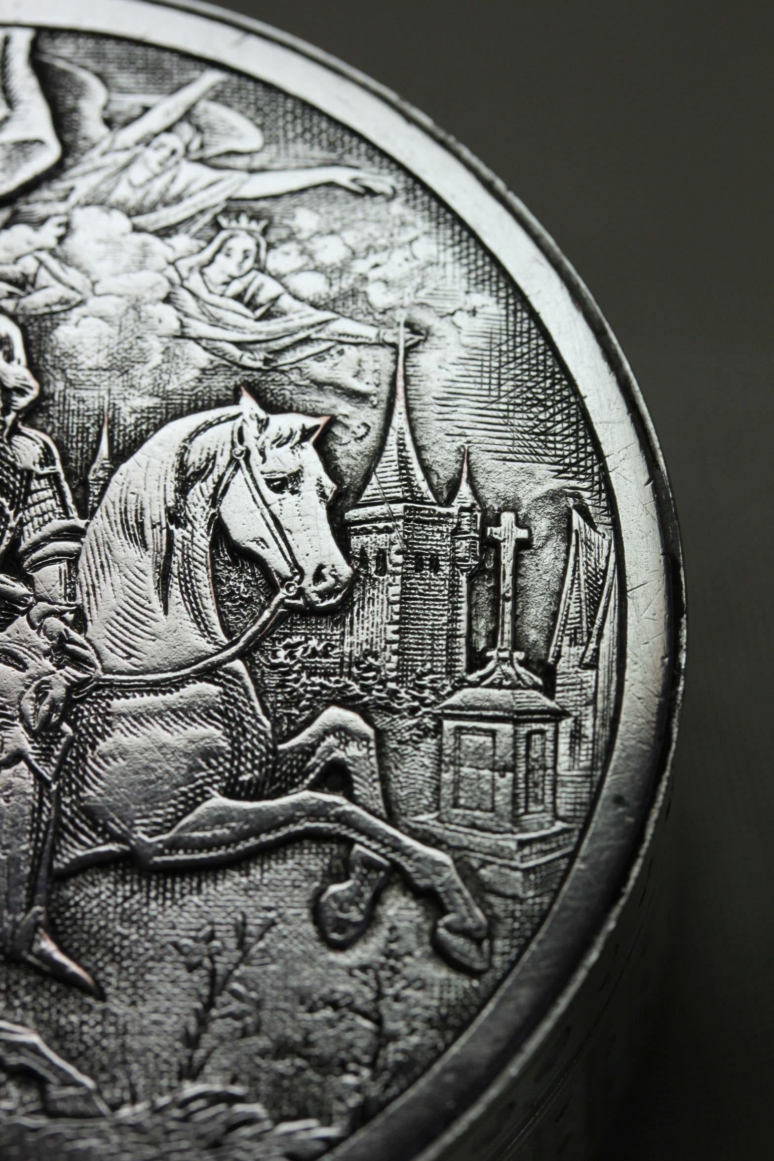 The lid of this French round silver plated box features a very detailed and intricate depiction of Joan of Arc on a horse. The detail extends to the buildings in the background, the angels in the clouds and part of her motto 