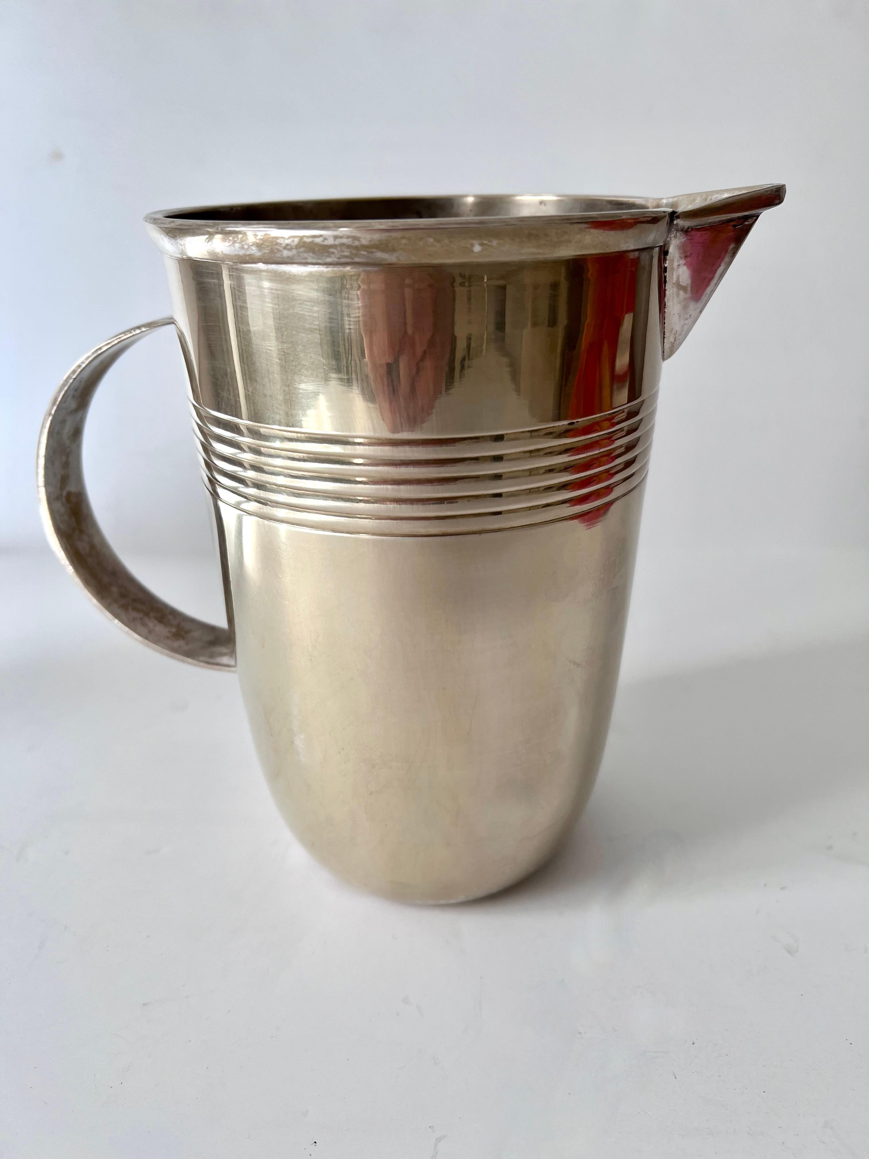 Acquired in Paris France, an early 20th century cocktail pitcher or Juice Pitcher. A Beautifully moderne design that compliments any bar or cocktail station. A lovely piece with Art Deco details.