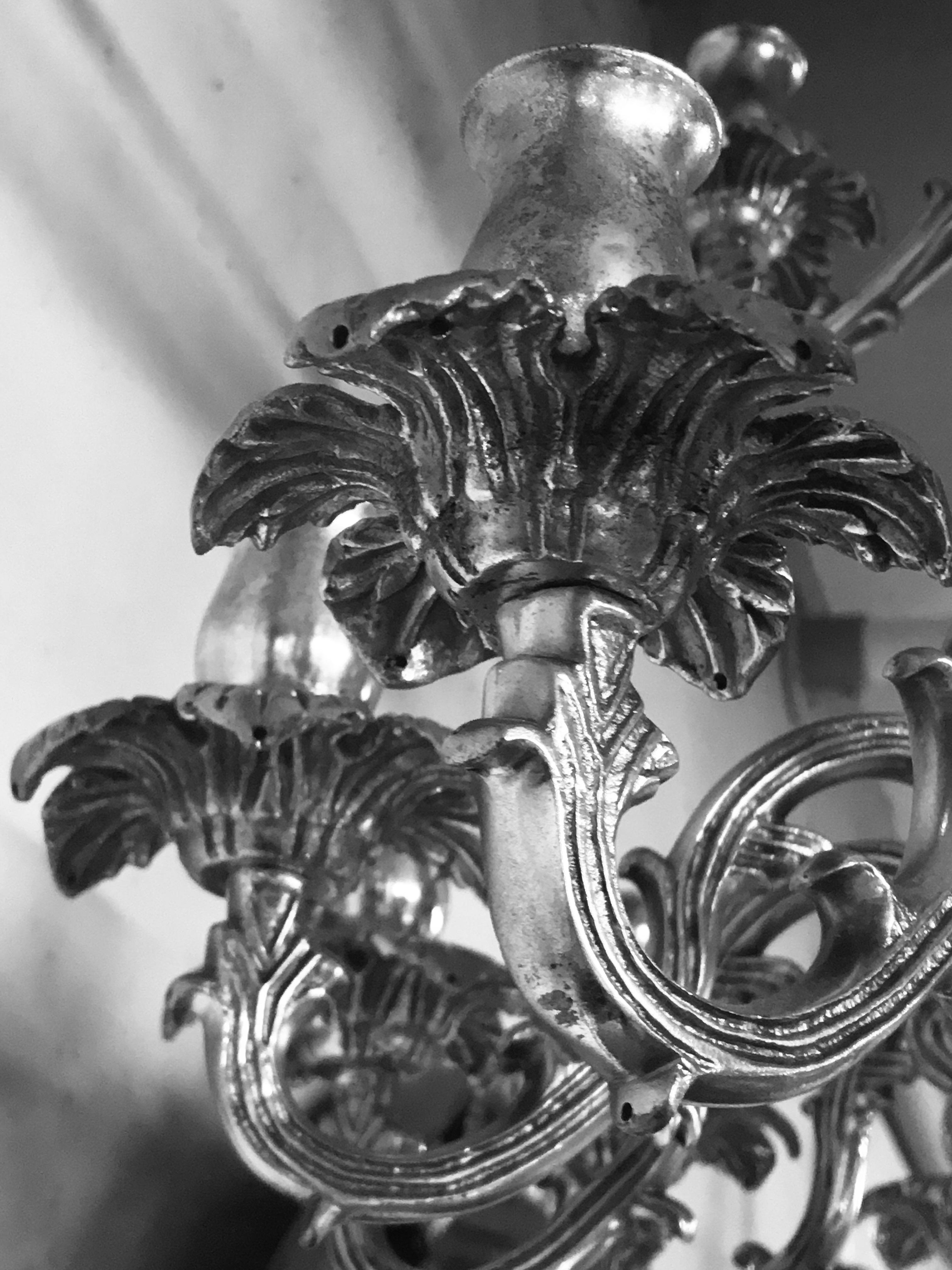 A large French, three-tier, twenty one branch silver plated chandelier. Of unusual design with foliate drip pans.
  
