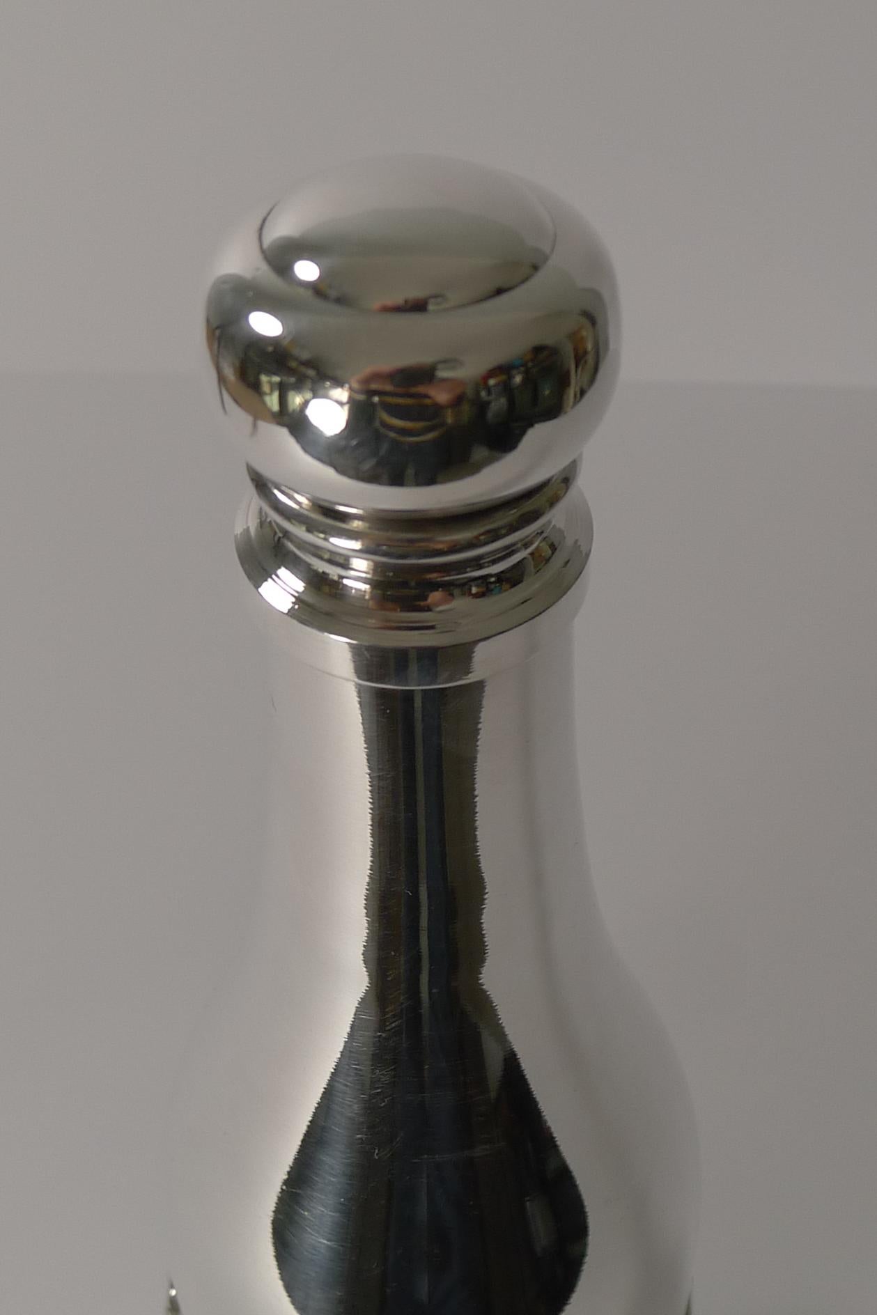 A fabulous vintage French cocktail shaker very much in the manner of famous French designer, Maria Pergay, with the rope and tassels that wrap around the Champagne bottle.

Made from silver plate, it is fully marked on the underside 