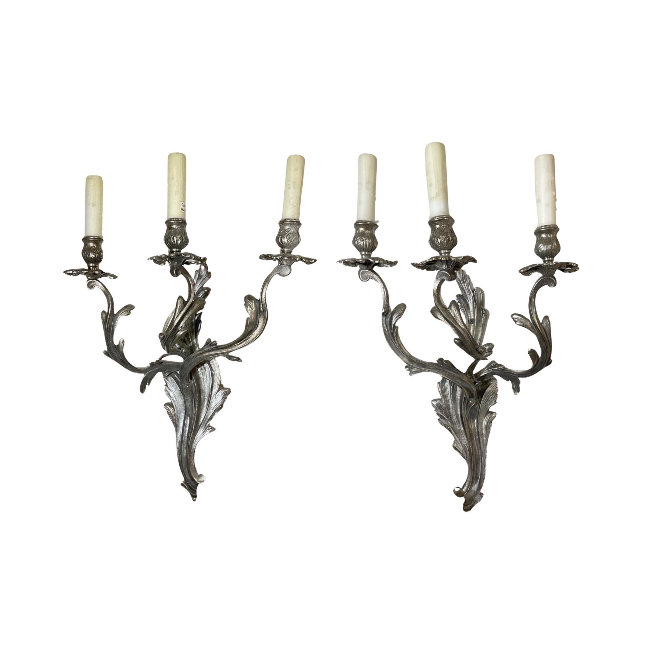 This pair of French Silver Sconces, circa 1880, feature ornate silver detailing and a classic design, perfect for any living space. Handcrafted from silver in France, this pair boasts quality construction and craftsmanship. Add a touch of elegance