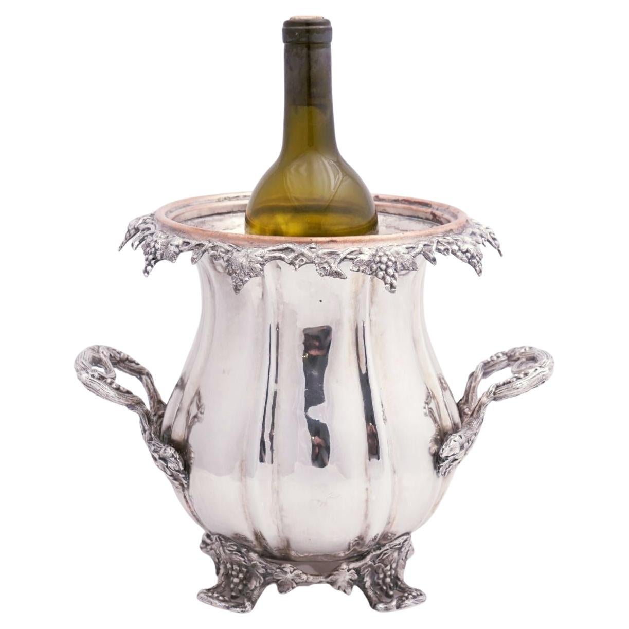 A beautiful pair of French wine coolers or champagne buckets of fine plate silver from the 19th century - each cooler featuring an elegant design of a gourd accented with a relief of grapes and grape leaves, opposing handles and a footed base with a