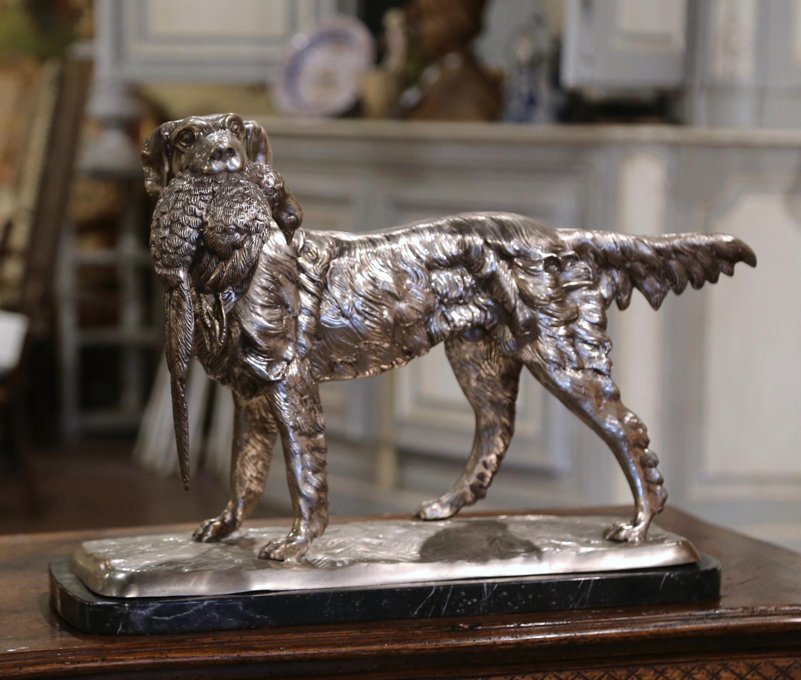 Decorate a man's office or library with this elegant dog and bird sculpture in the manner of Jules Moigniez. Created in France circa 2010, and standing on a rectangular green marble base, the composition depicts a proud hunting setter holding a
