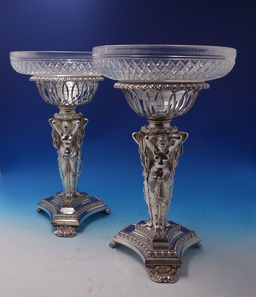 
Outstanding antique figural French silverplate pair of centerpieces with cut crystal bowls, the bases surrounded by figural Art Nouveau partially nude women, in Greek draped dress, circa 1880 (maker unknown). They each measure 15