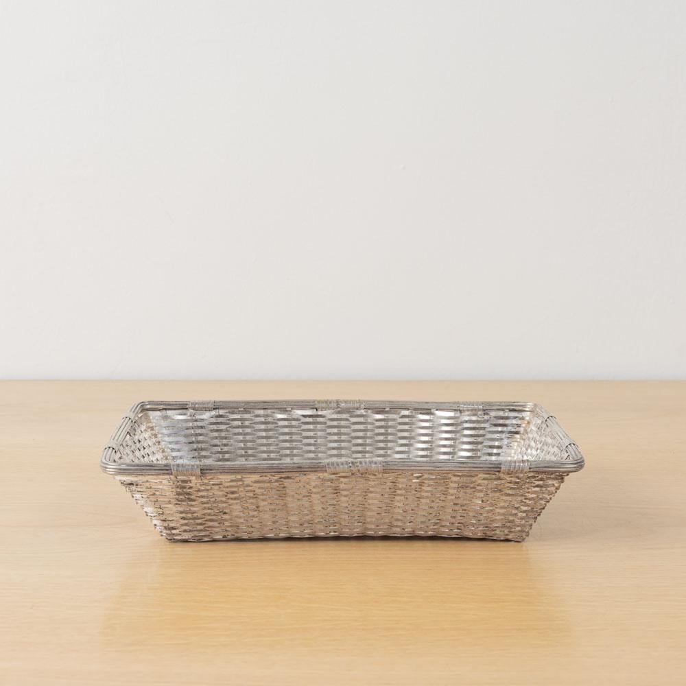 Incredible vintage silver plated basket by Christofle Gallia from France. Rectangular basket made of woven silver plate with nice ribbed edge detailing. Finish shows nice age and patina. Unique piece perfect as a decorative object or catch-all.