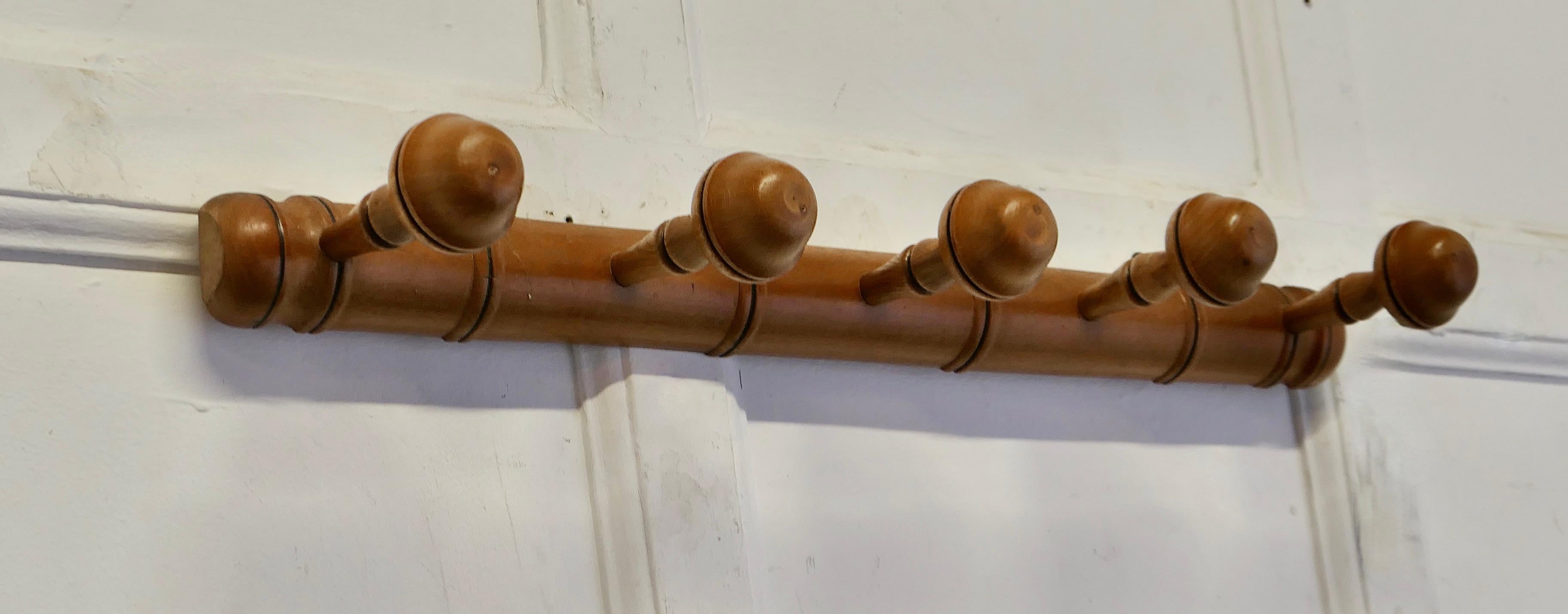 French Simulated Bamboo Hat and Coat Wall Rack

A Very attractive Coat Rack, made in beech to simulate bamboo, the rack has a row of 5 turned coat hooks  
A Great piece, and in good condition
The Rack is 3”high and 24” long and it stands out 6” from