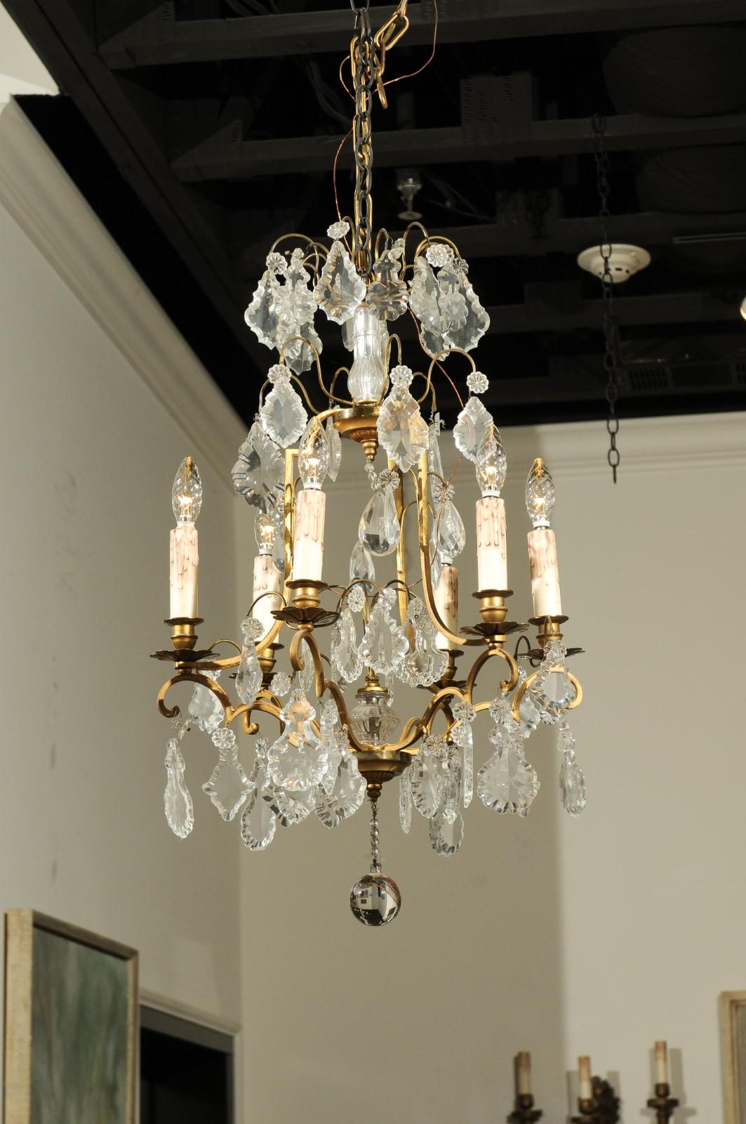 A French six-light crystal chandelier from the late 19th century, with brass armature and crystal column. Born in France during the later years of the 19th century, this lovely chandelier features a brass structure adorned with a central crystal